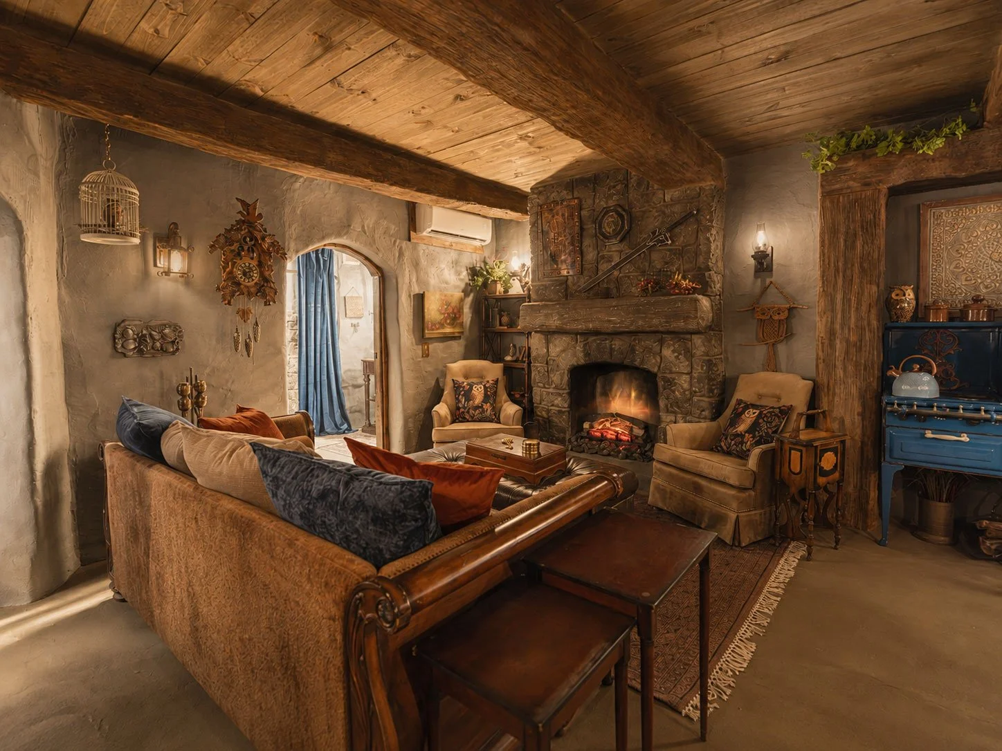 Cozy hobbit living at Mirador Texas with stone fireplace, wooden ceiling, vintage furniture, and warm lighting.