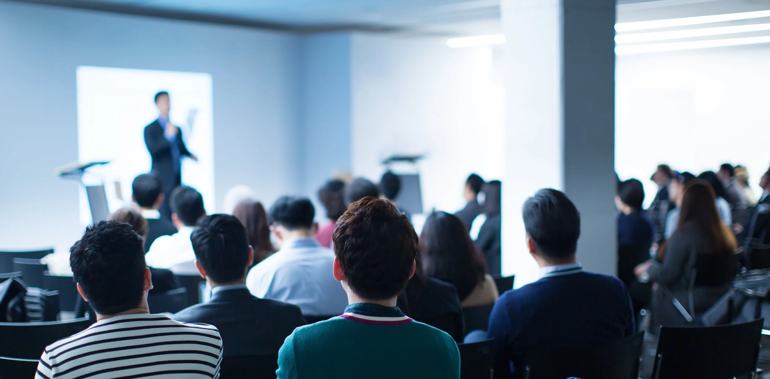 Presenter speaking at a live event