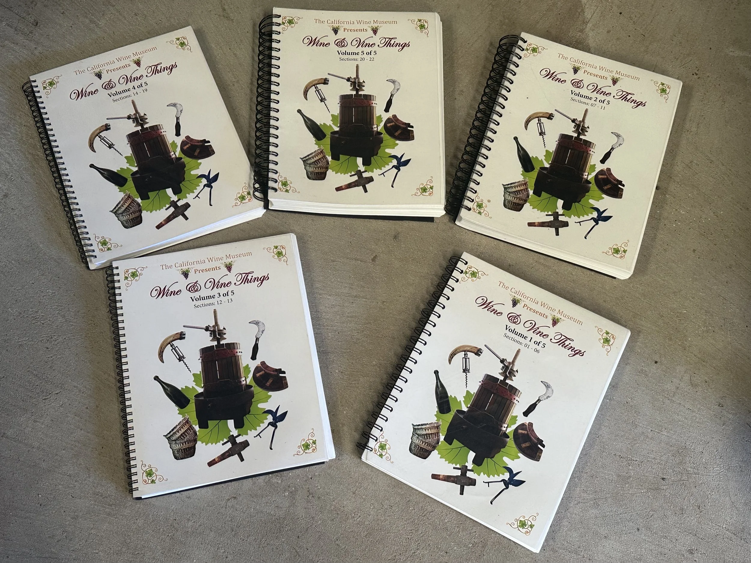Five Wine & Vine Things catalogs on a table.