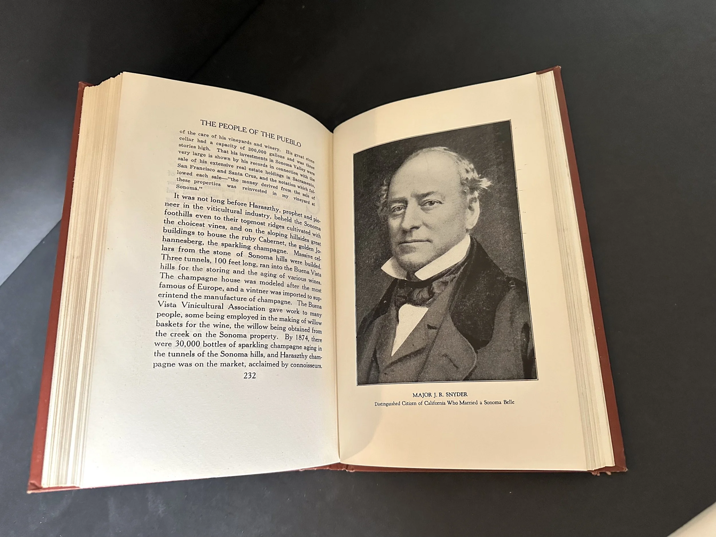An open book with text on the left and an image of Major J.R. Snyder on the left