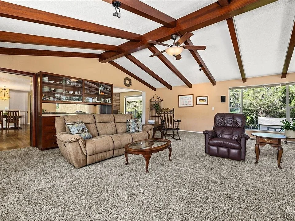 Existing front living room. Its vaulted ceiling and hearth provide the starting point for a quieter place to read or talk together.