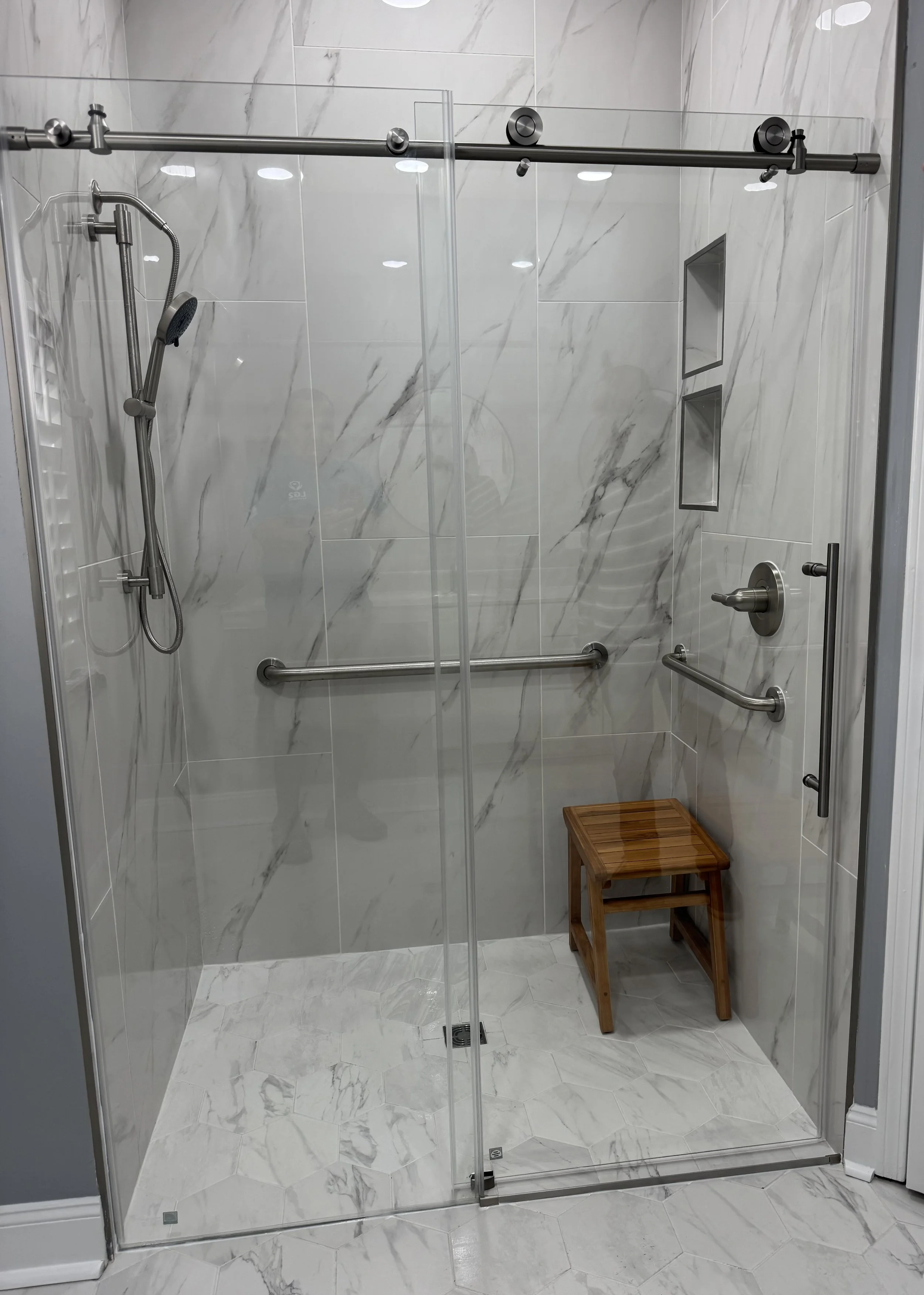 Modern bathroom remodel completed by LG2 Services featuring a walk-in shower, custom tile, and updated fixtures in Jacksonville, Florida.