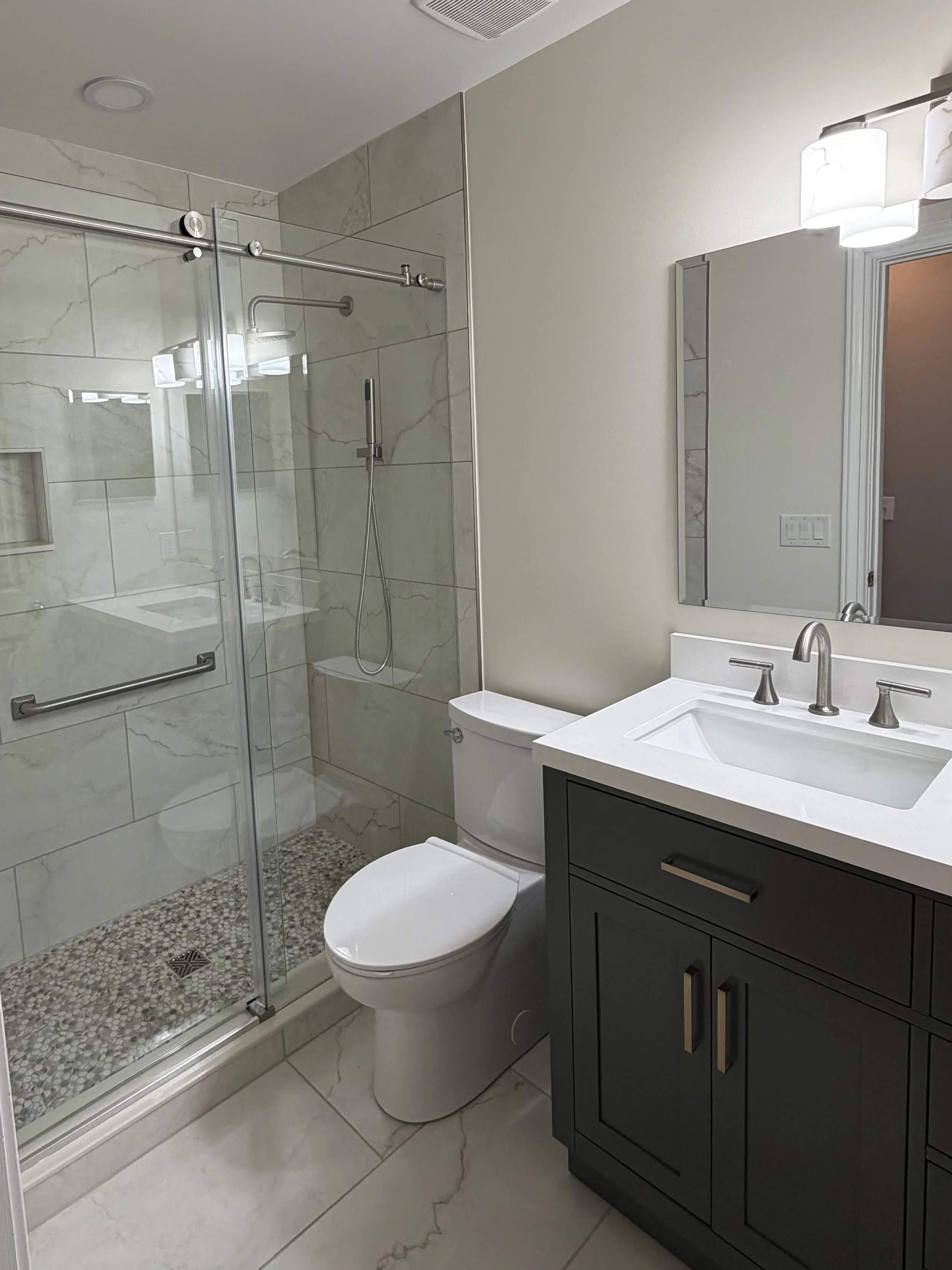 Completed walk-in shower remodel with custom tile, modern fixtures, and premium finishes by LG2 Services in Jacksonville, Florida.