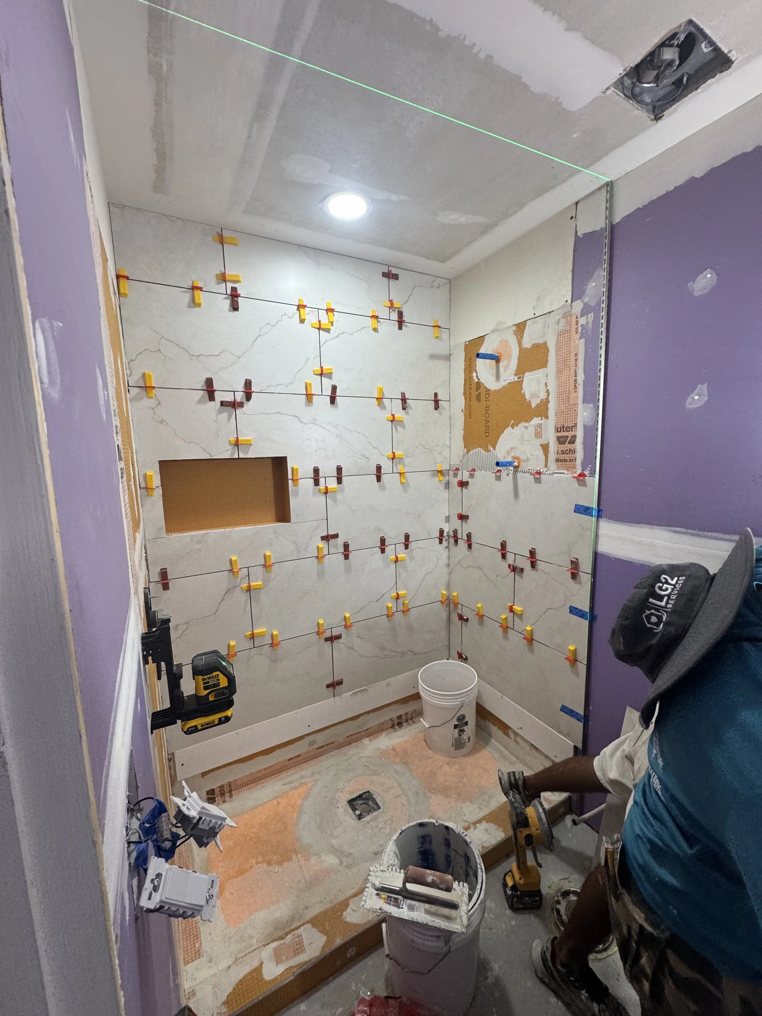 Bathroom demolition in progress during a tub-to-shower conversion by LG2 Services in Jacksonville, Florida.