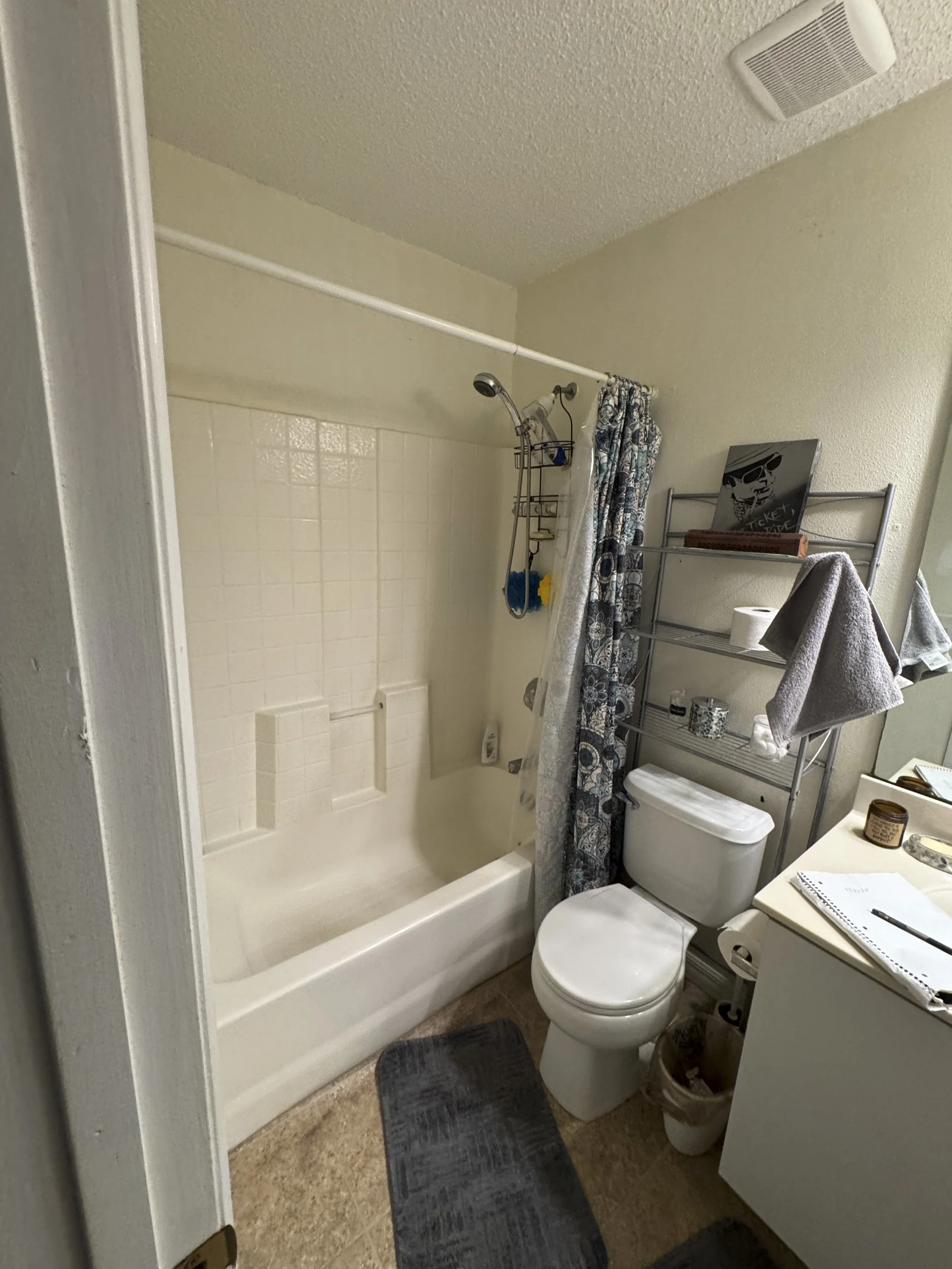 Before photo of an outdated bathroom with a soaking tub prior to a complete walk-in shower remodel by LG2 Services in Jacksonville, Florida.