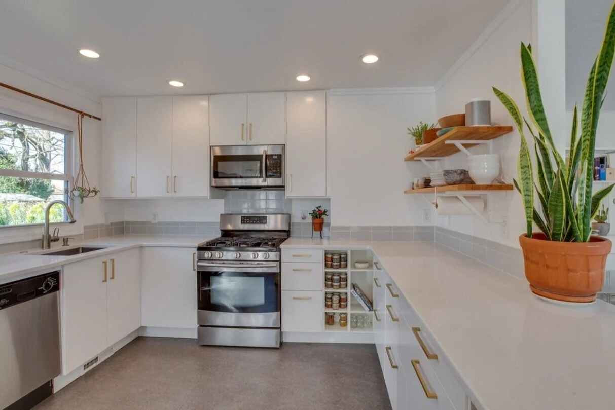 To-the-studs kitchen remodel. New tankless water heater, plumbing and sink location, recessed lighting, semi-custom cabinets and shelving, quartz countertops, tile backsplash and all new appliances