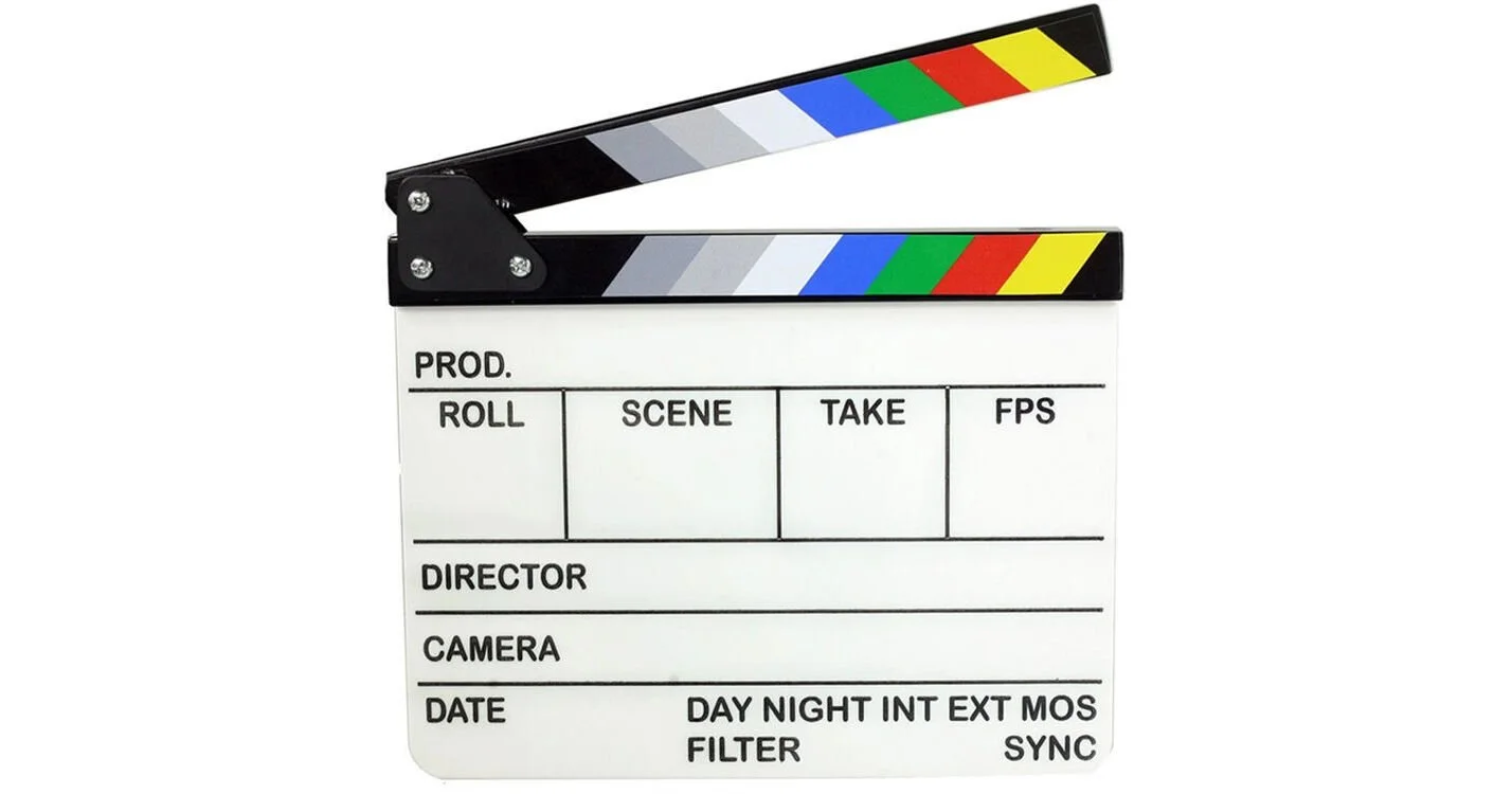 A movie clapperboard with black, white, gray, blue, green, red, and yellow colors on the top section.