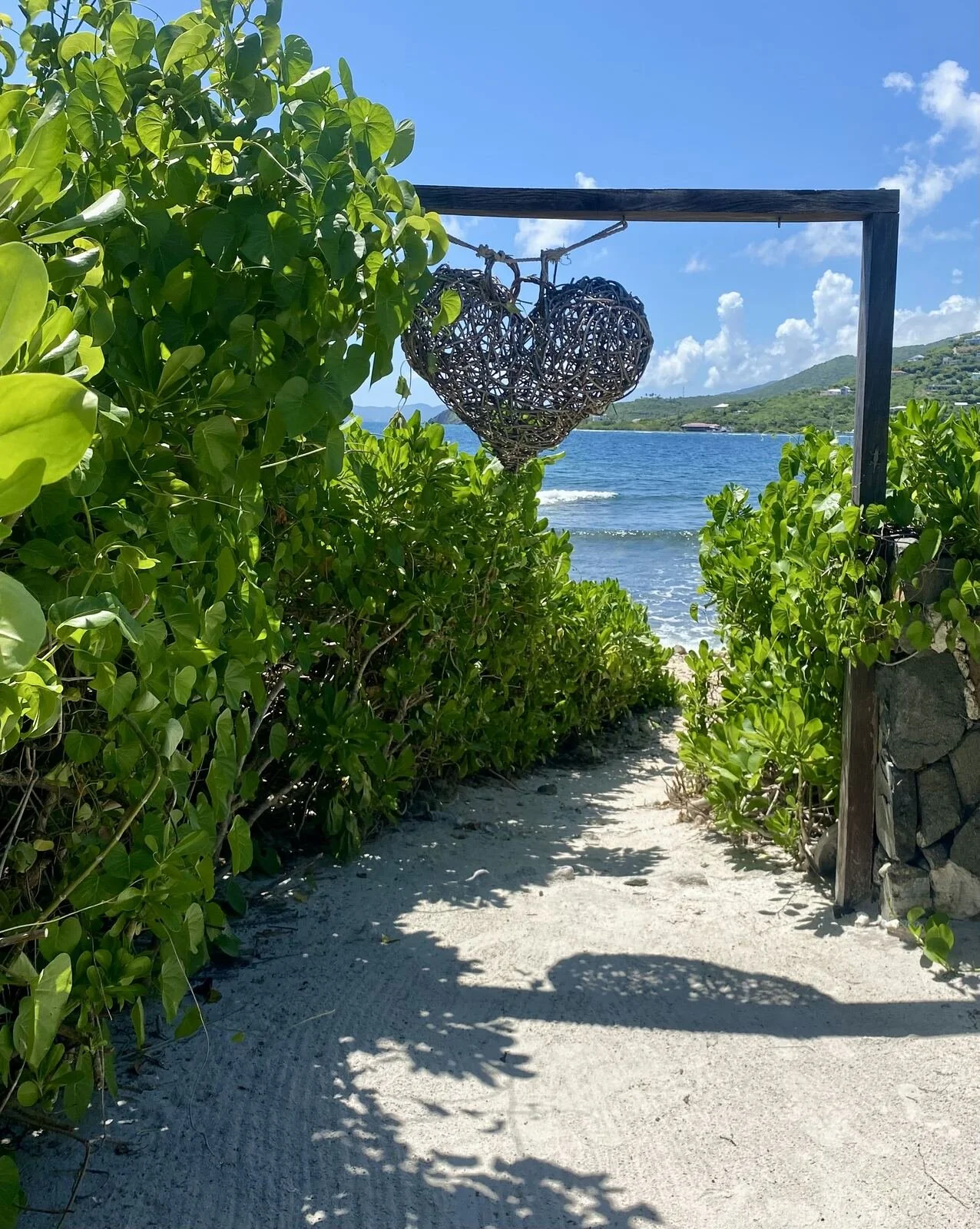 Wire heart art in front of tropical beach