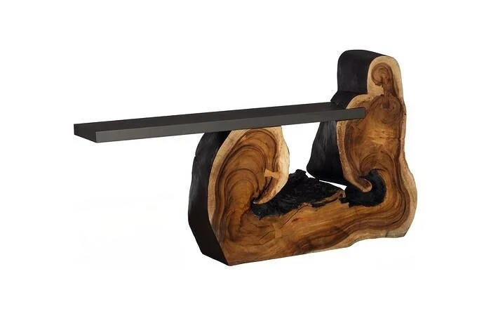 A modern desk made from a large piece of wood with a metal tabletop attached.