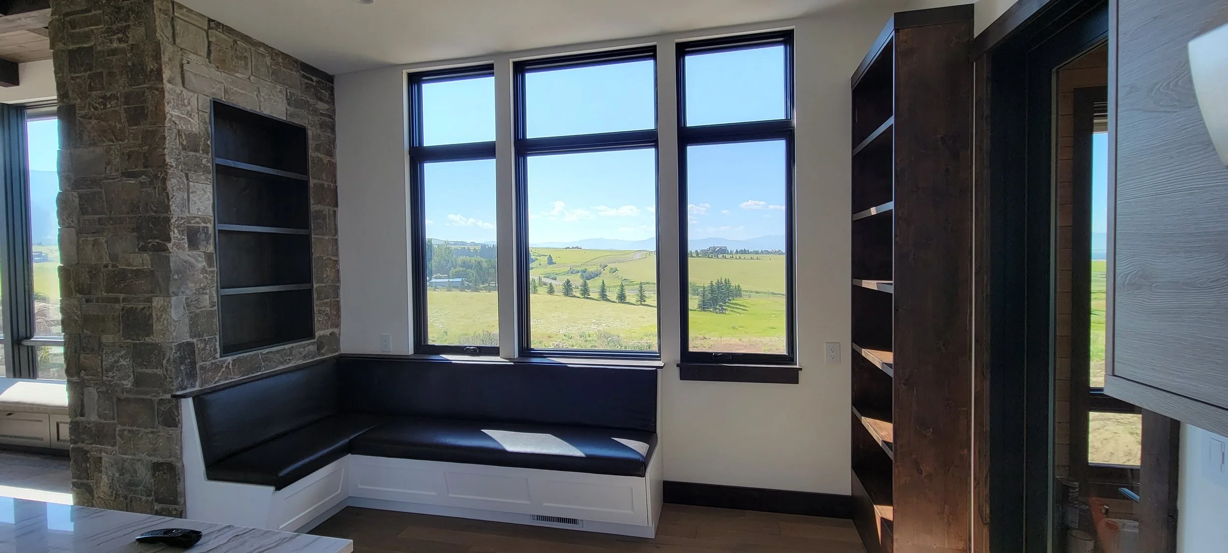 Built-in Breakfast nook with upholstered seat cushions and custom storage shelving