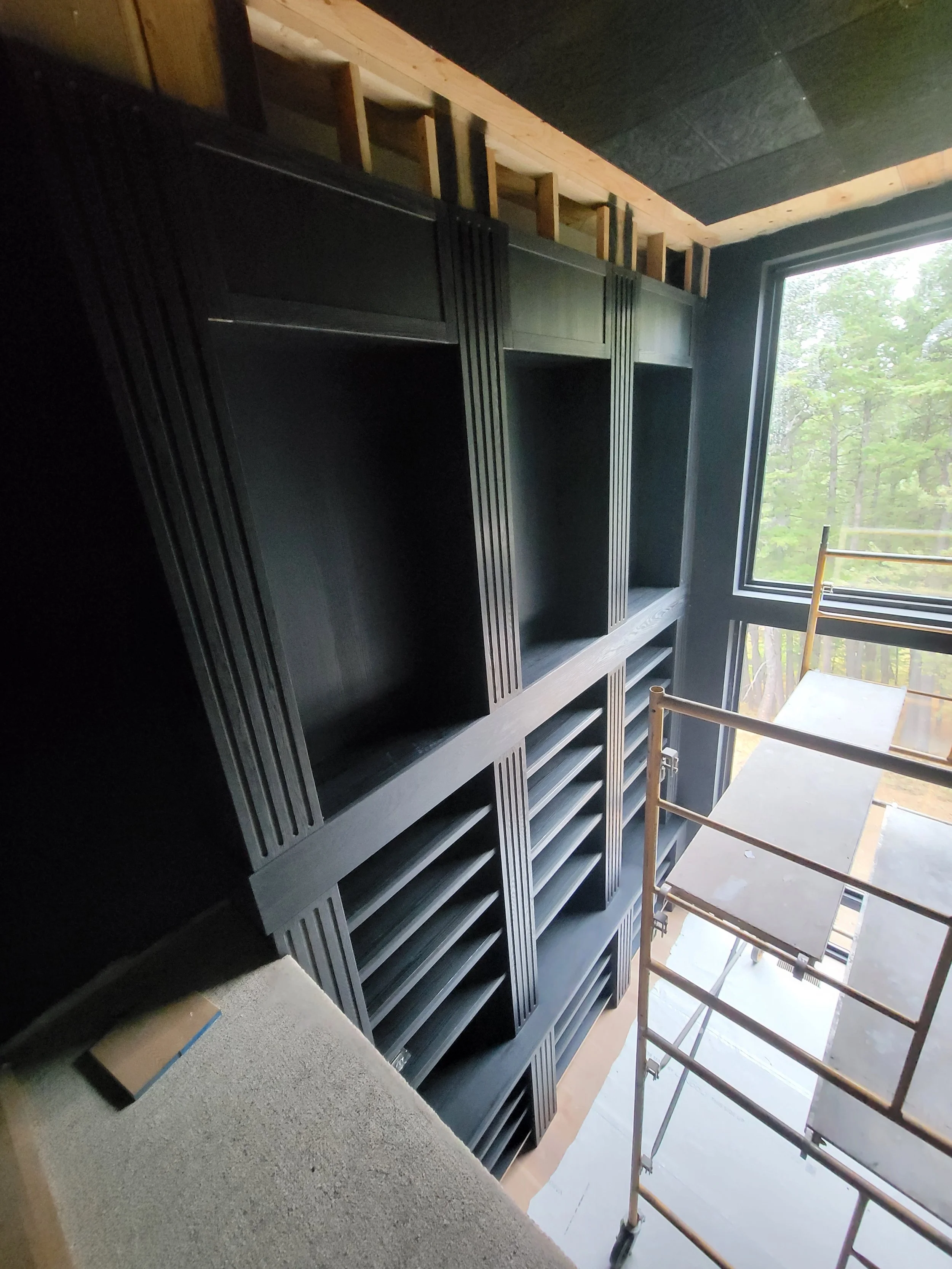 Library in progress. Custom milled and fluted red oak, stained deep black