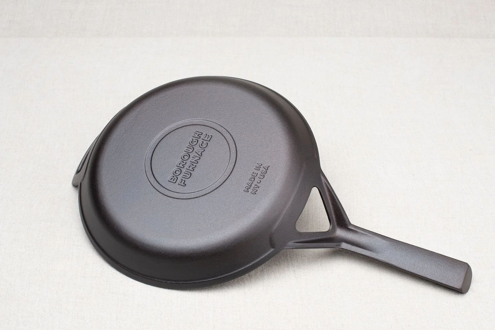 Bottom of Borough Furnace 10.5-inch cast iron skillet showing maker's mark and Made in USA stamp