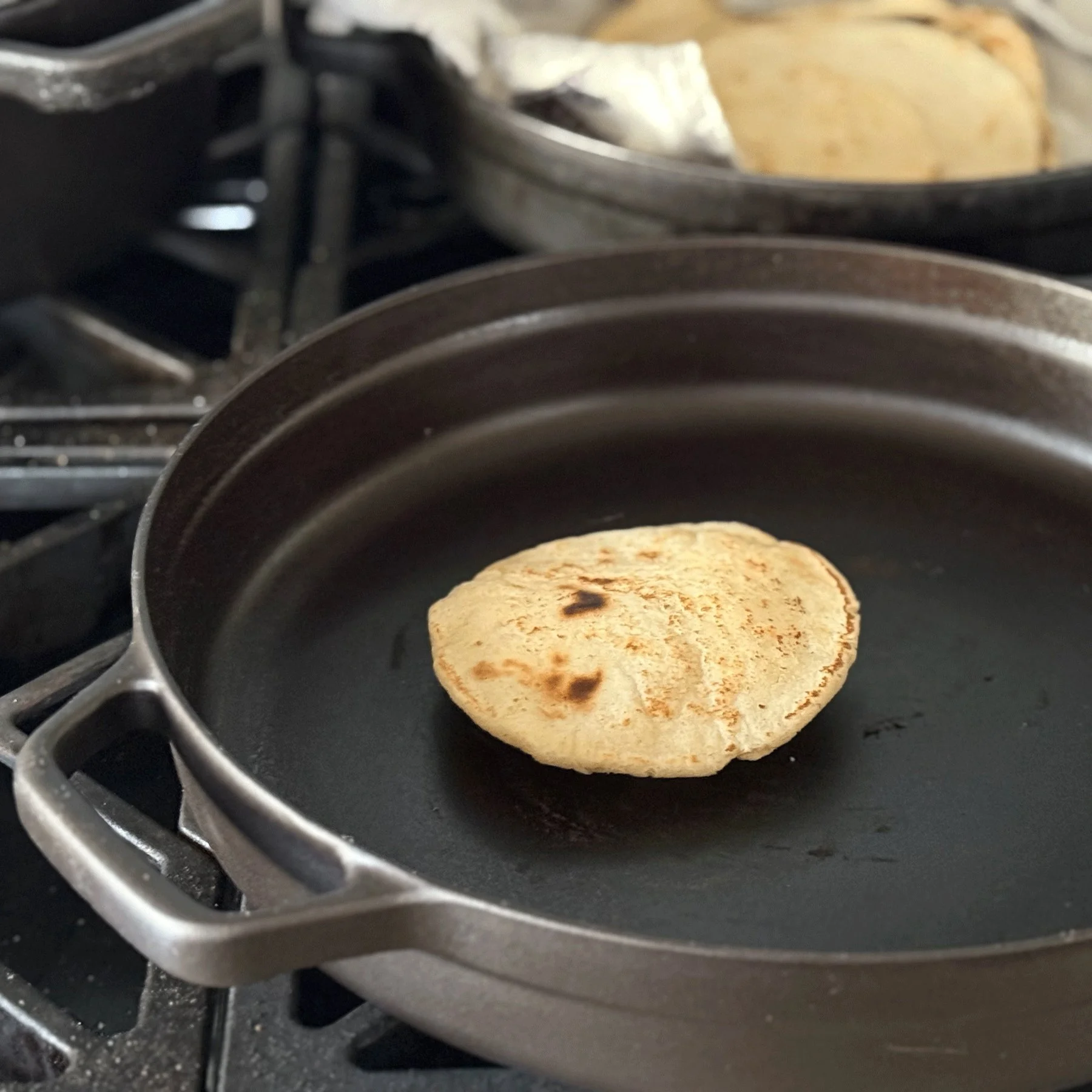 A homemade masa harina tortilla in a Borough Furnace cast iron skillet