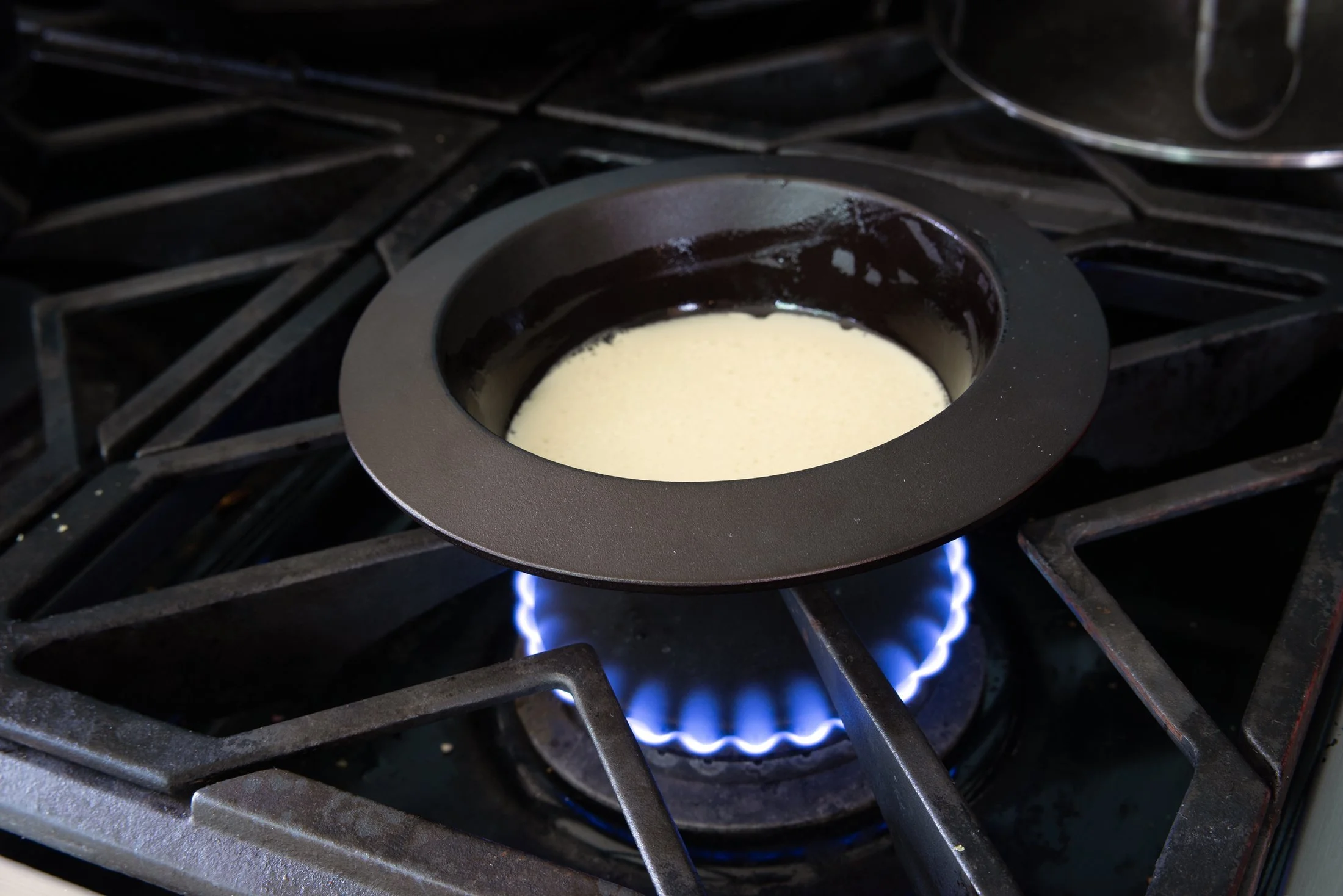 Custard cooking in a cast iron cazuela by Borough Furnace