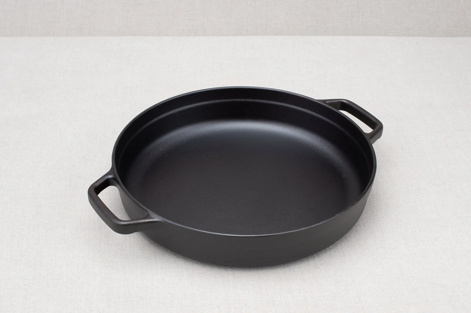 Borough Furnace 12-inch cast iron braising skillet, angled view on white background