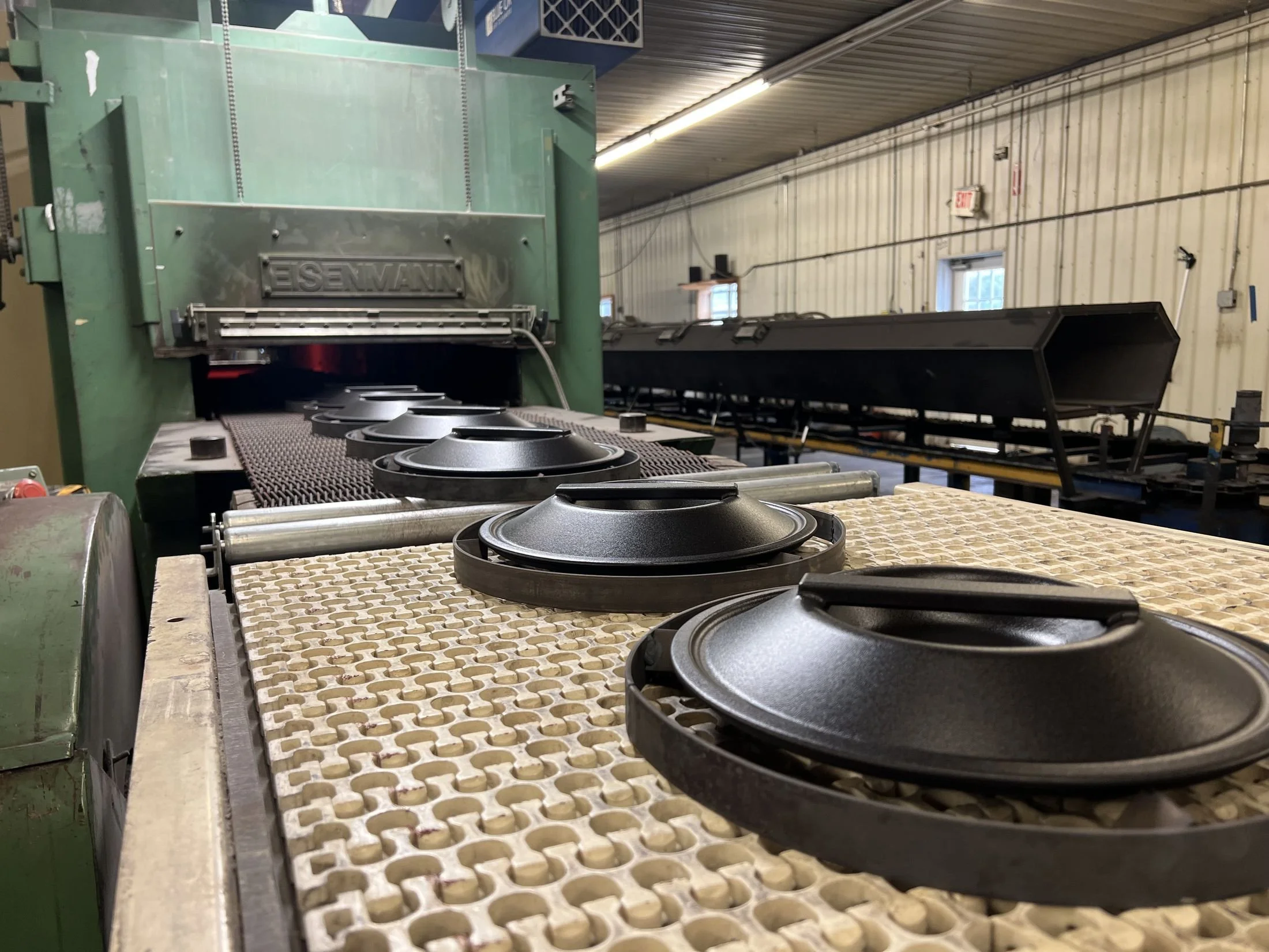 Borough Furnace Dutch oven lids on the enamel kiln conveyor