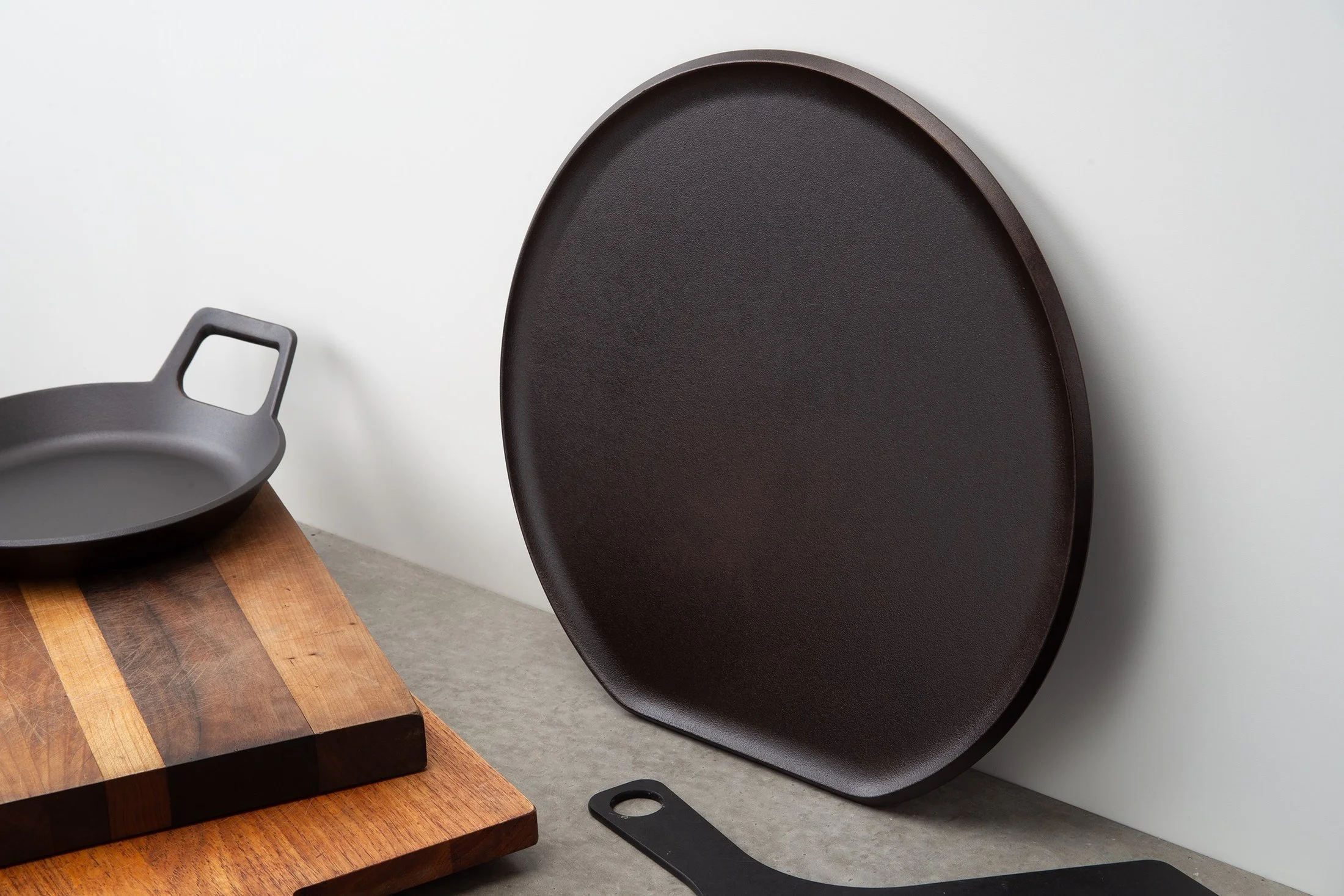 Pizza griddle leaning against the wall