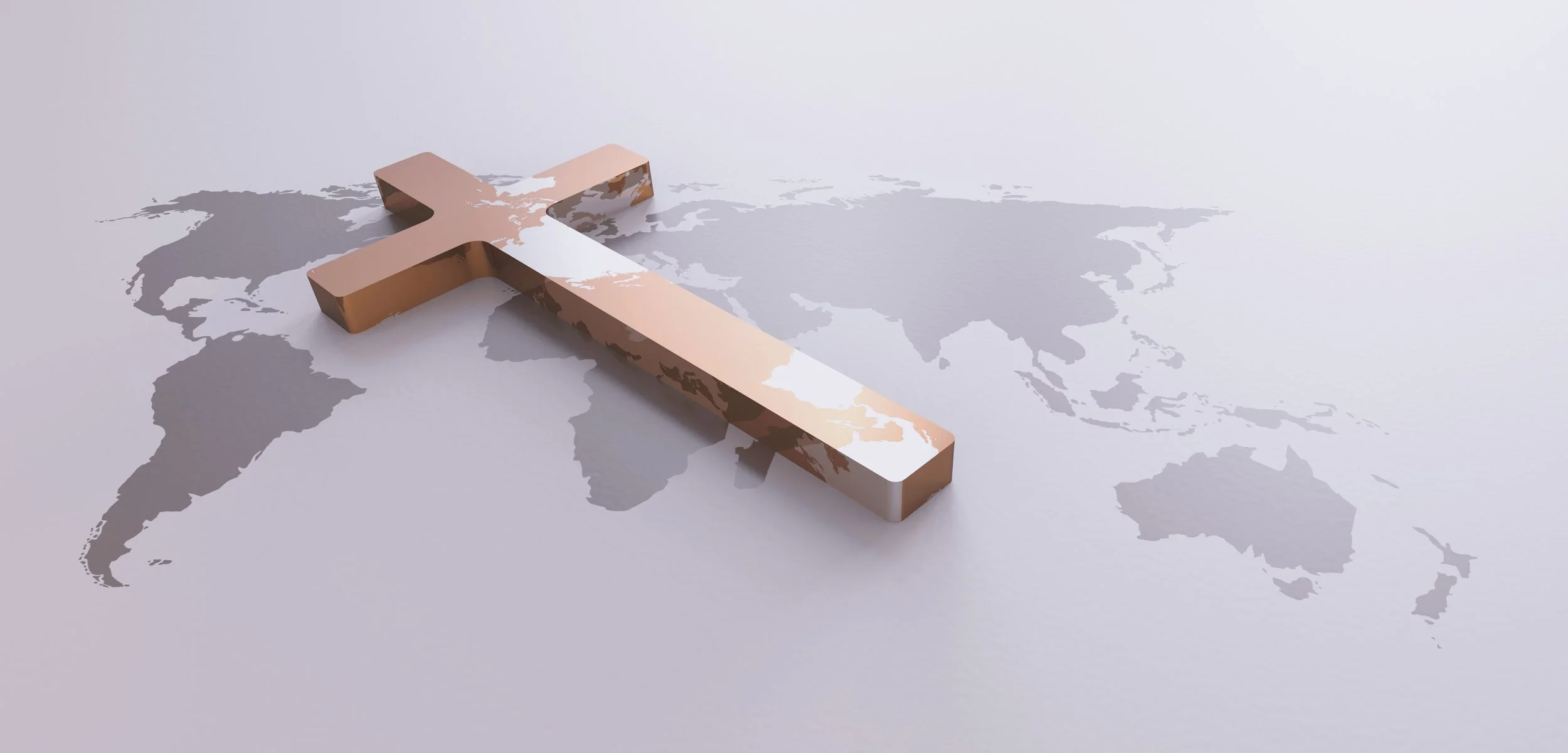 Wild Goose Studios - Let's create something meaningful. A metallic cross placed on a world map with continents in gray on a light background.