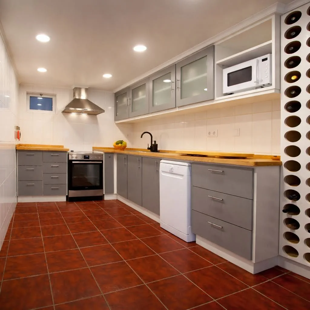Modern kitchen with gray cabinets, a white dishwasher, microwave, stove, and a black sink faucet, with wooden countertops and red tiled floor.