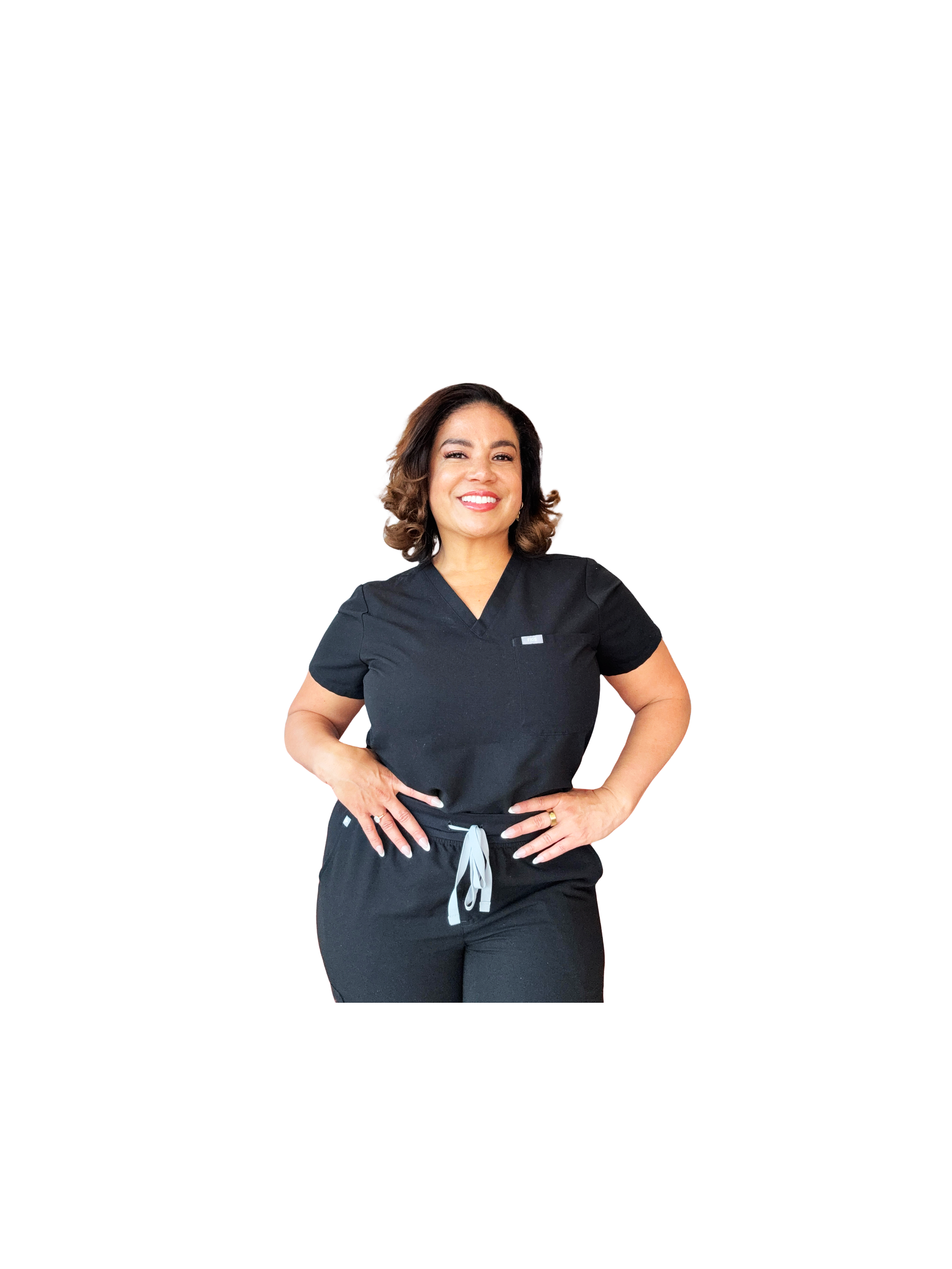 A woman smiling, wearing black scrubs with short sleeves and a drawstring waist, standing with her hands on her hips against a white background.
