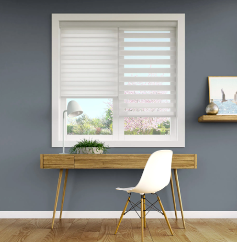White zebra shade on a window in a modern home office with gray walls and a natural wood desk