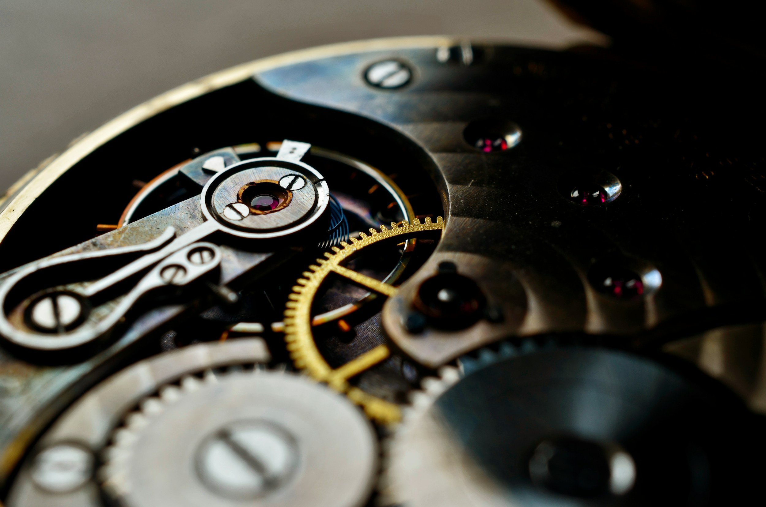 Close-up view of the intricate inner gears and mechanical components of a watch movement.