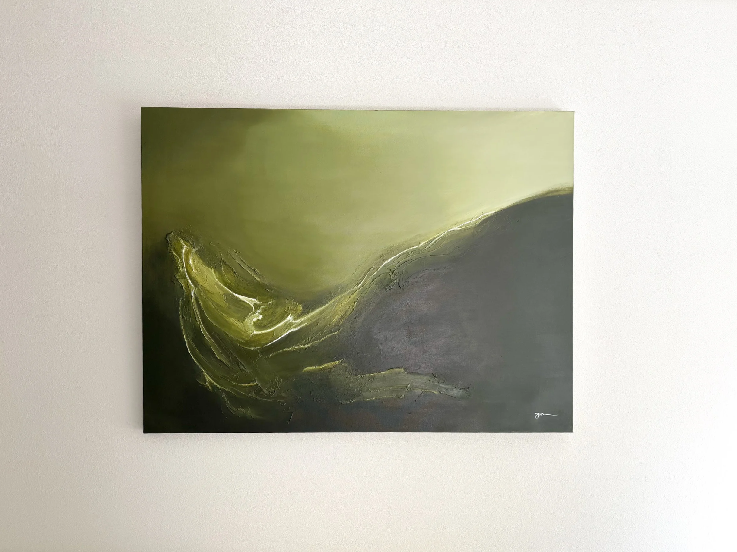 A painting with abstract swirling green and dark green colors hanging on a white wall.