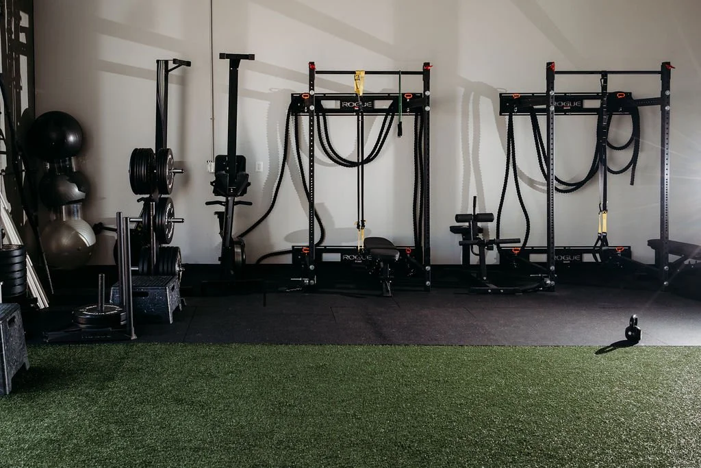 Private Performance Studio – Golden, CO: Fully equipped for strength, plyometric, and speed work. Green turf and black equipment designed specifically for performance training.