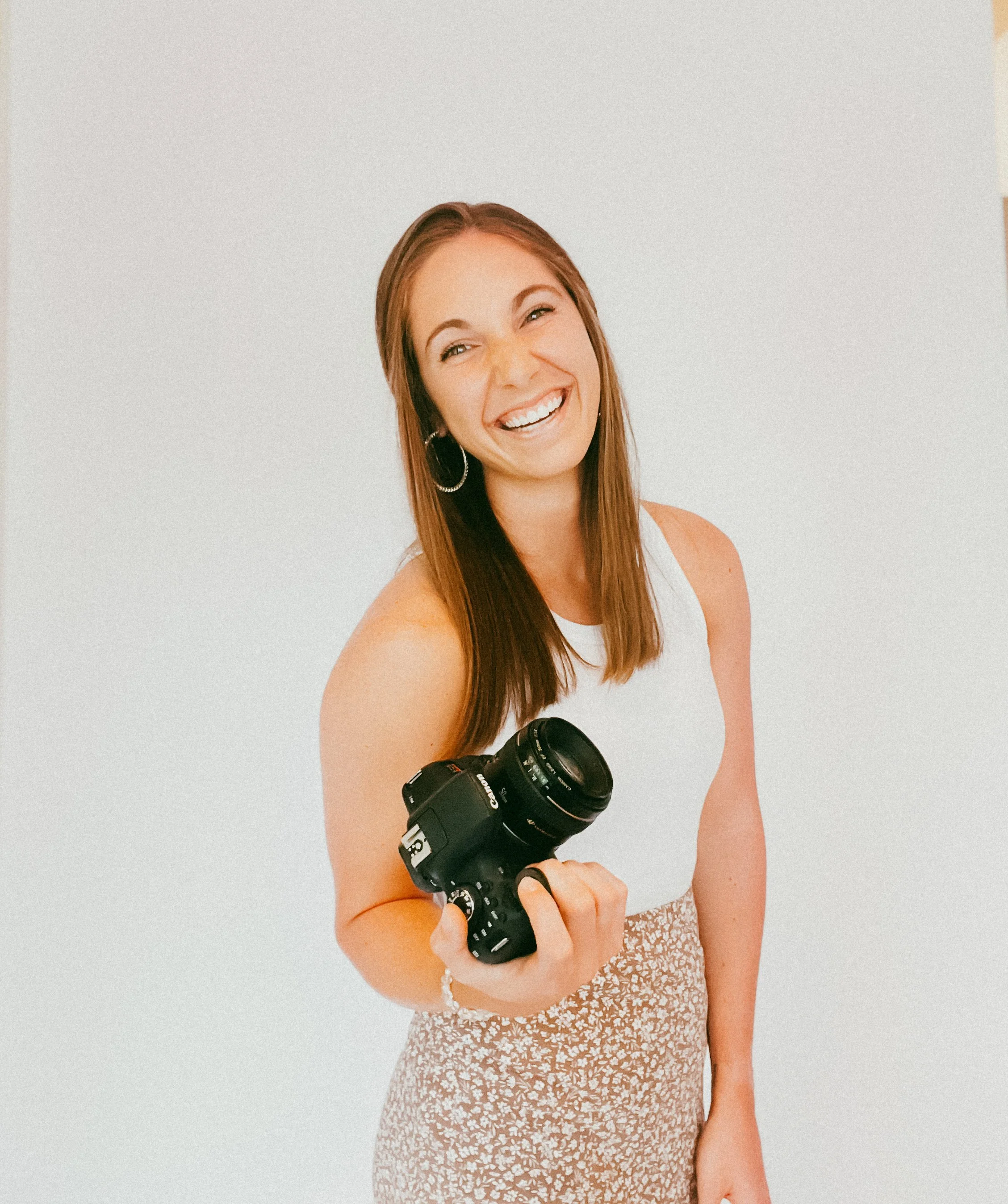 Lauren Fuhrmann, KC-based brand photographer and social media strategist, holding a Canon camera