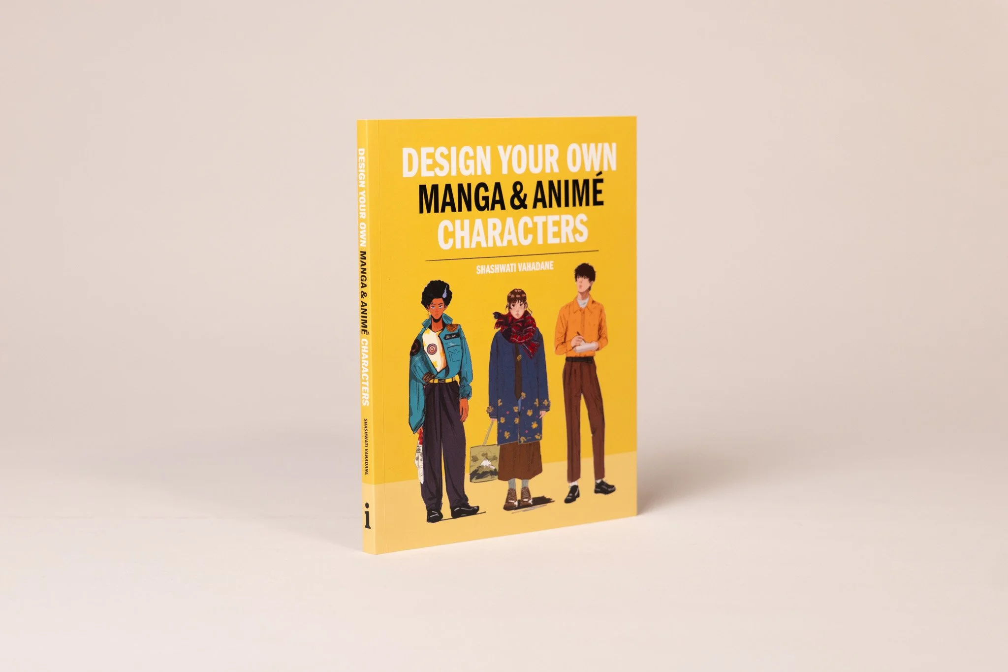 Yellow book titled 'Design Your Own Manga & Anime Characters' by Shashwati Vahadane stands upright on a plain surface, featuring illustrations of three diverse manga characters on the cover.
