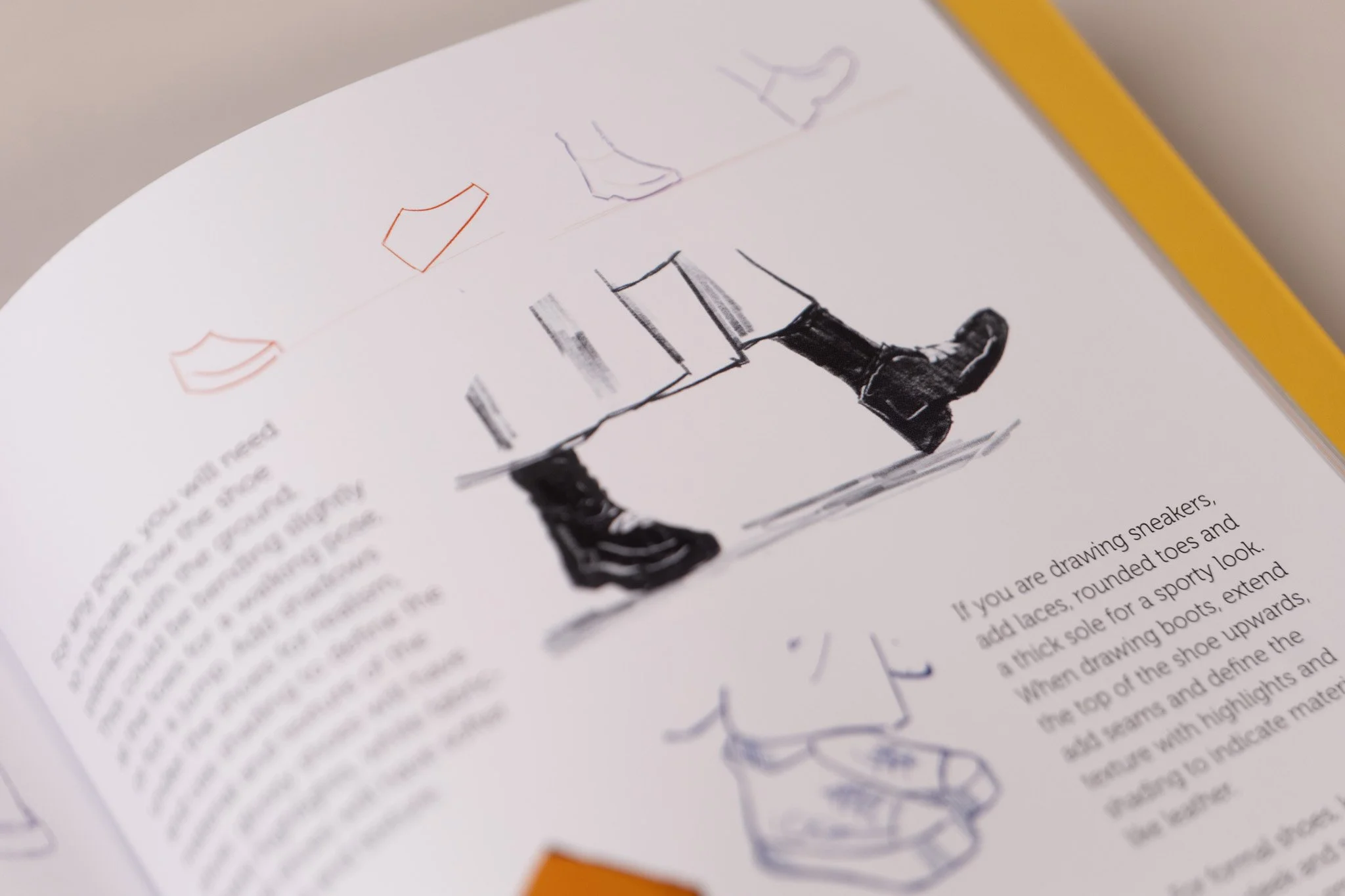 Sketch of a pair of black boots, along with outline drawings of socks and other shoe-related elements.