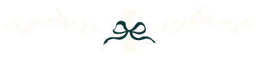 Decorative graphic of a darling white dog bone tied with a ribbon and flanked with botanical elements.