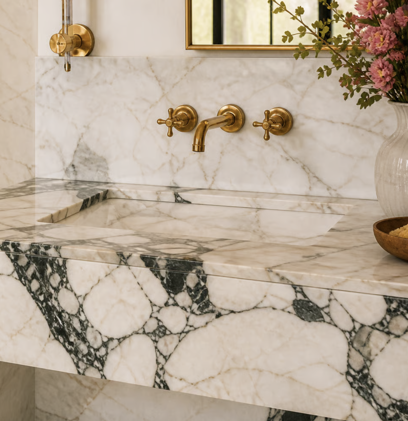 Marble bathroom vanity detail with brass wall-mounted fixtures — NYC interior design by Elle Emme Atelier