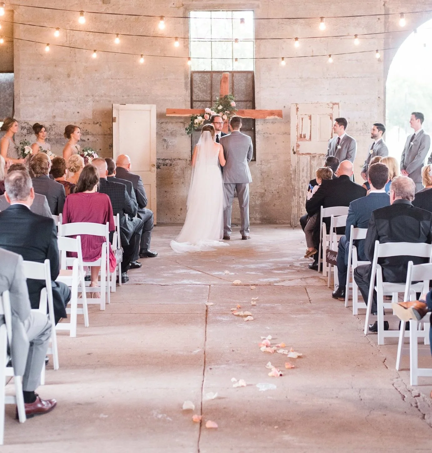 Friends and family watch on as wedding officiant presents ceremony.