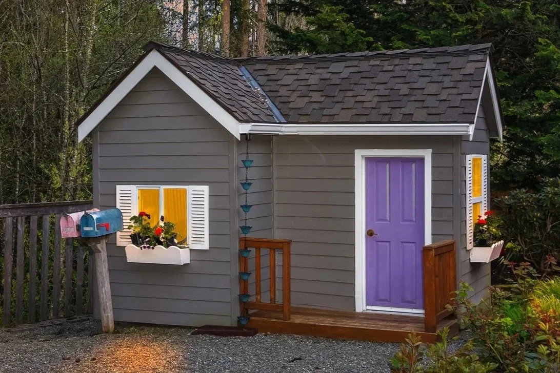 AFTER: Playhouse siding repaired, gutters installed, rain downspout installed, deck repaired and stained