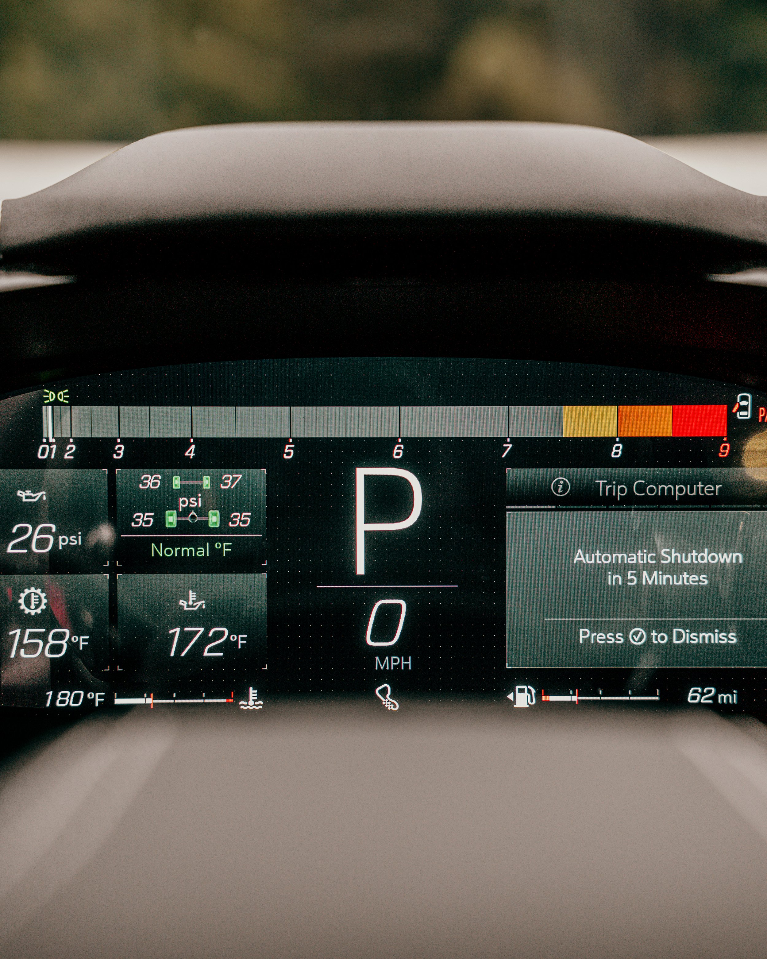 The car's digital dashboard display shows the vehicle is in park, with a tire pressure of 26 psi at the front left, 36-37 psi at the front right and rear right, and 35 psi at the rear left. The temperature gauges display 158°F and 172°F, with a coola