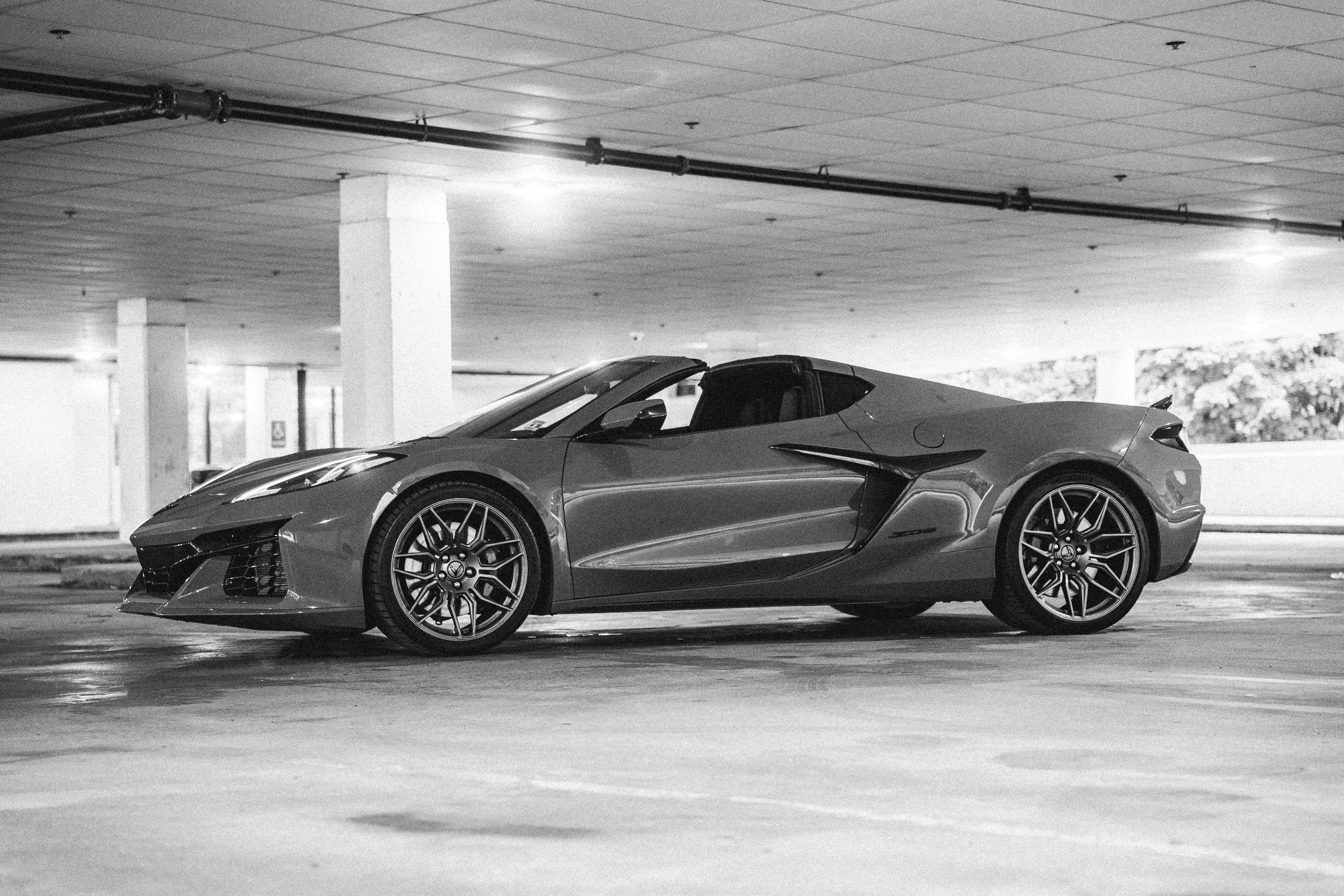 A sleek sports car parked in an underground parking lot.