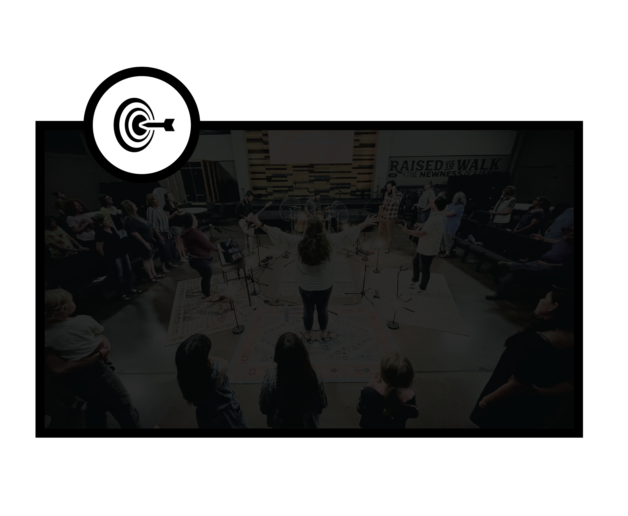 People gathered in a church or chapel for a worship service or choir practice, with a conductor in the center leading the group.