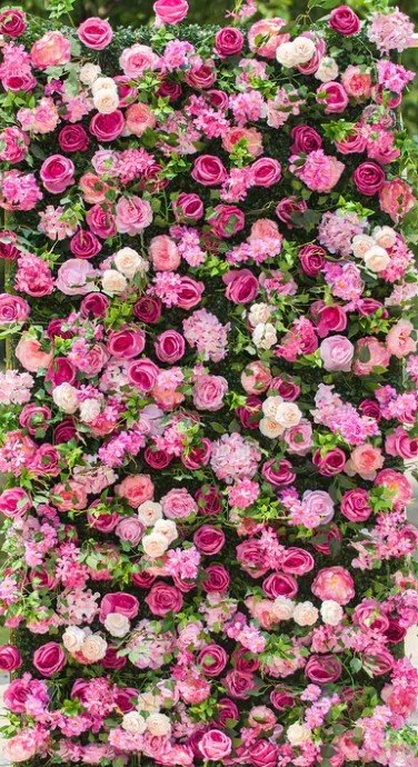 A dense display of pink, purple, and white flowers with green foliage.
