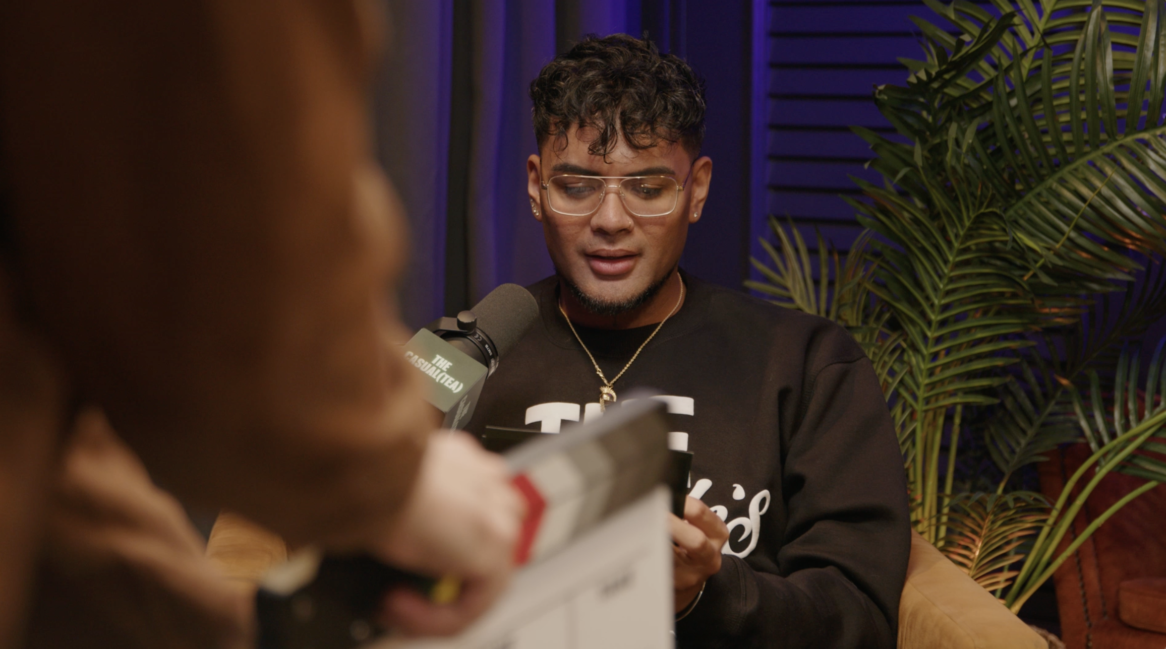 Kona Faamoe, entrepreneur, podcast host, and media personality recording The Casual Tea Podcast in a professional studio.