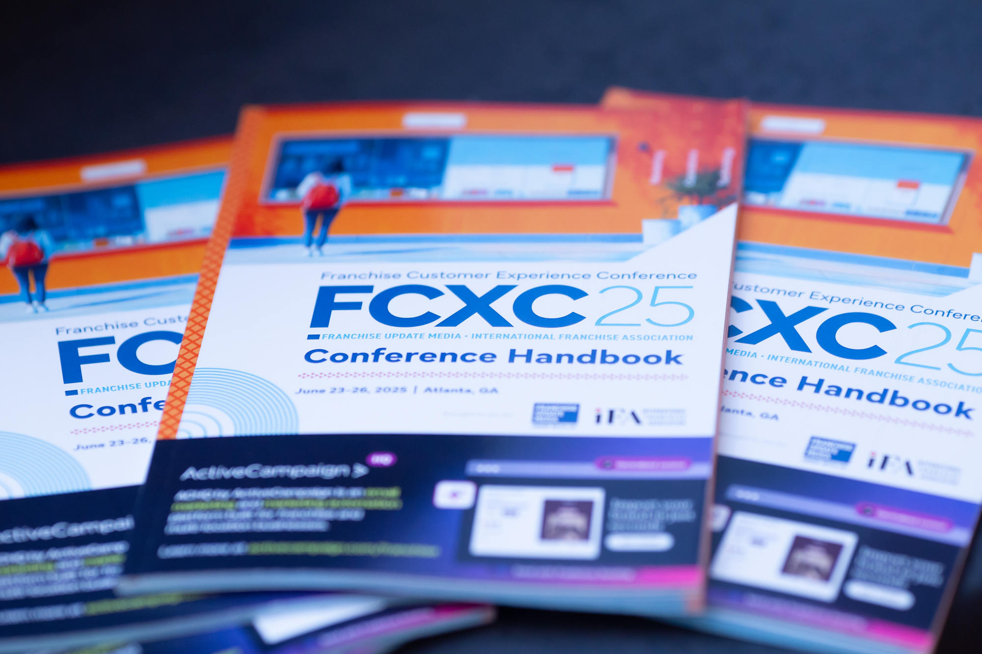 Conference programs titled 'FCXC 25' for the Franchise Customer Experience Conference.