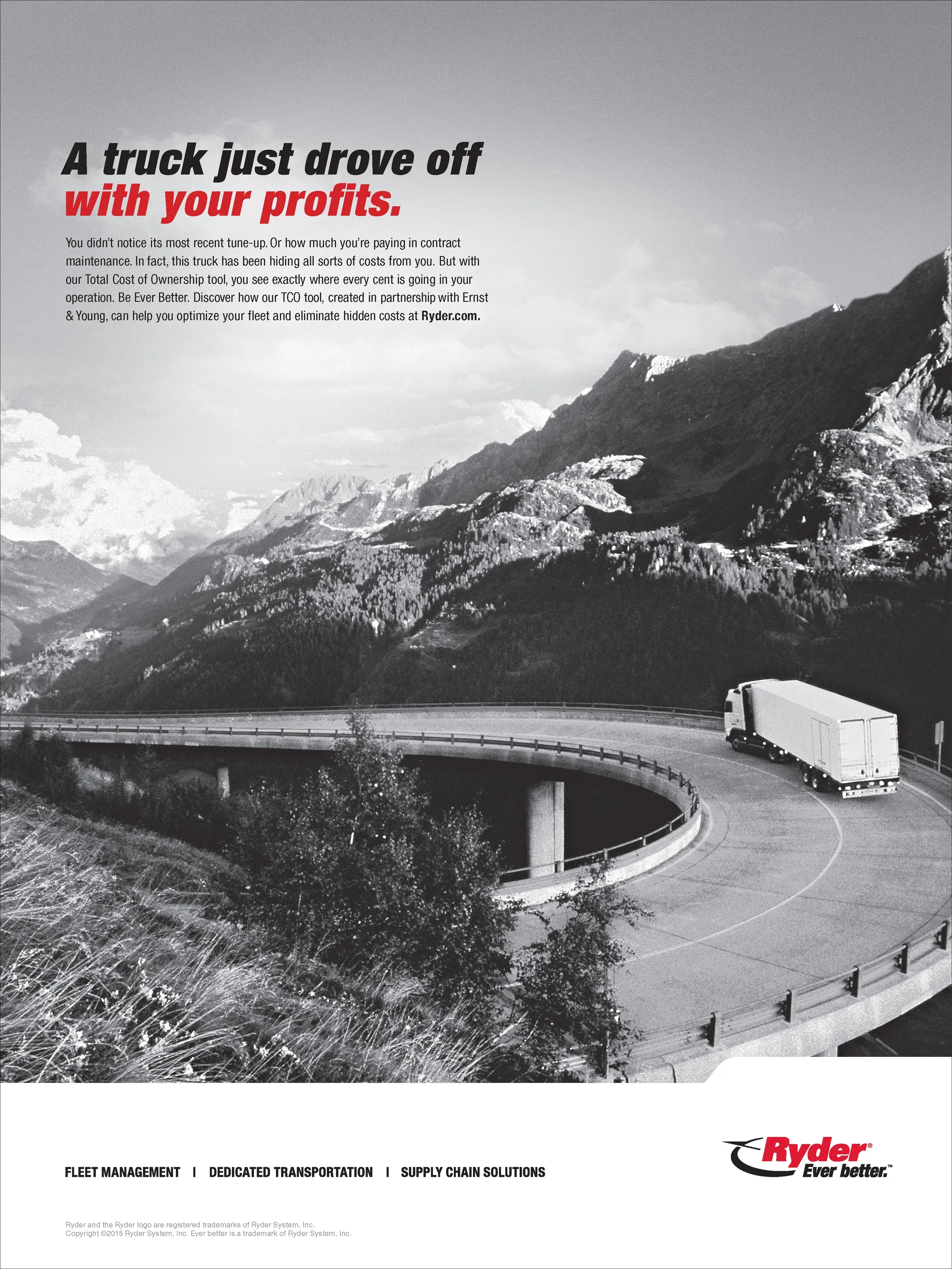 Black and white photo of a Ryder truck driving on a curved mountain road, with a mountainous landscape in the background, featuring rugged peaks and clouds.
