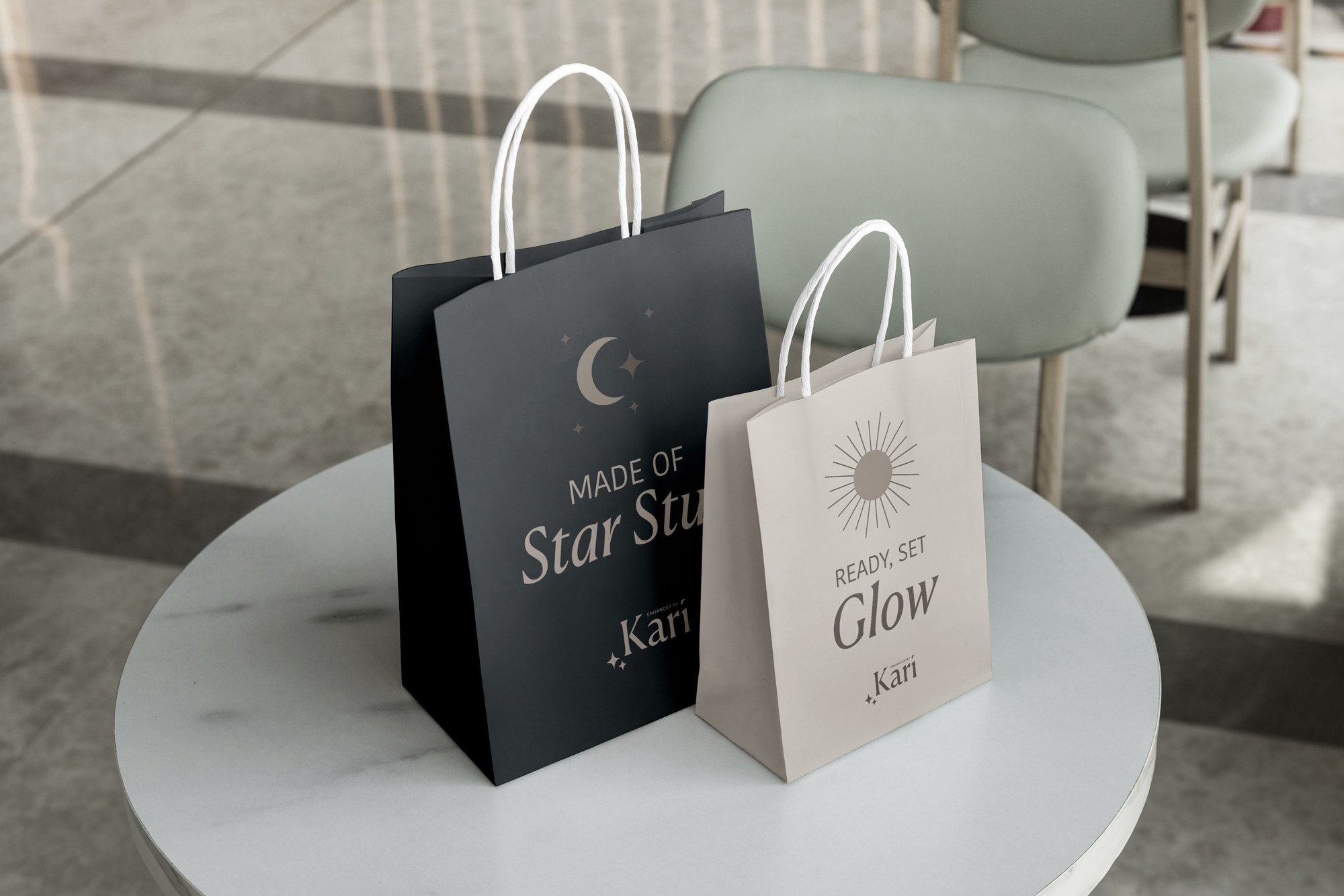 Two shopping bags on a white table, one dark blue with a moon and star design and the words 'Made of Star Stuff', the other white with a sun illustration and the words 'Ready, Set, Glow'.
