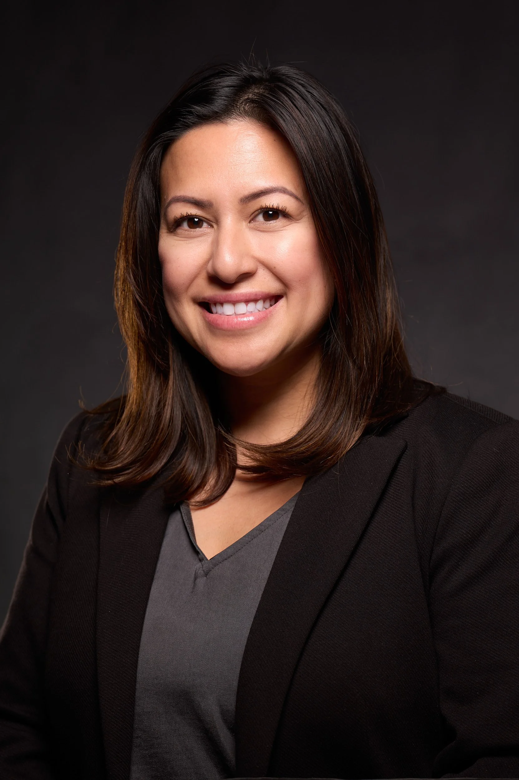 Professional corporate headshot of executive woman in black blazer by Arsen Vasquez Photography
