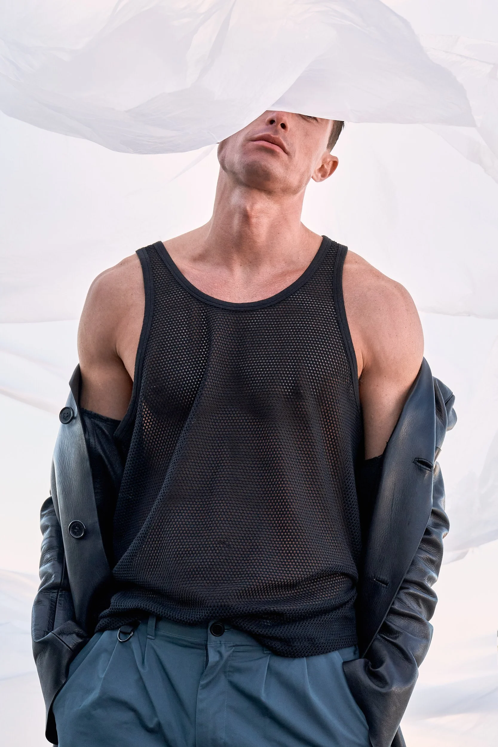 Editorial fashion photography by Arsen Vasquez, male model in tank top and jacket in Brooklyn, New York