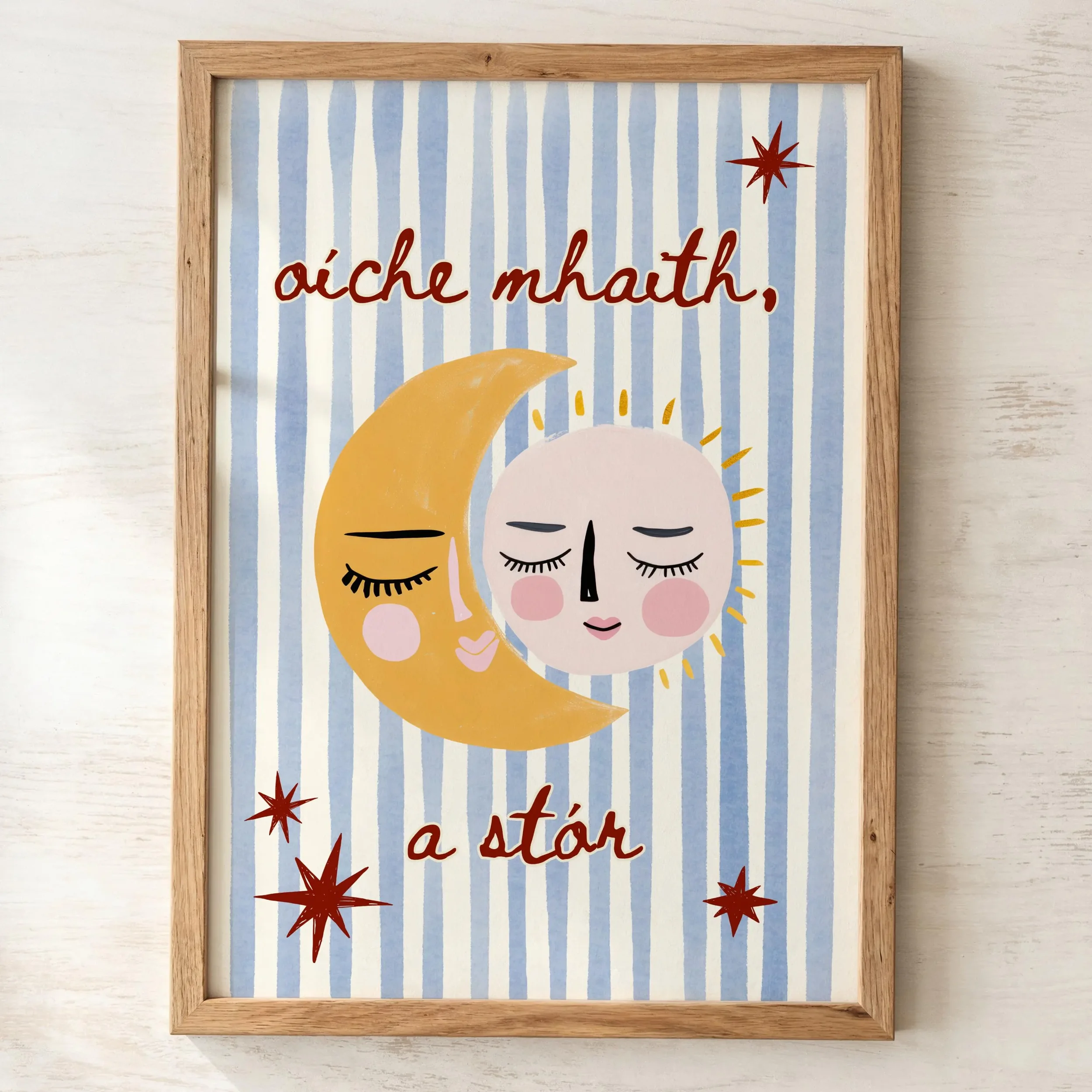 Decorative sign with the phrase 'oiche mhat, a star' written in red, surrounded by red starburst illustrations, mounted in a wooden frame on a white background.