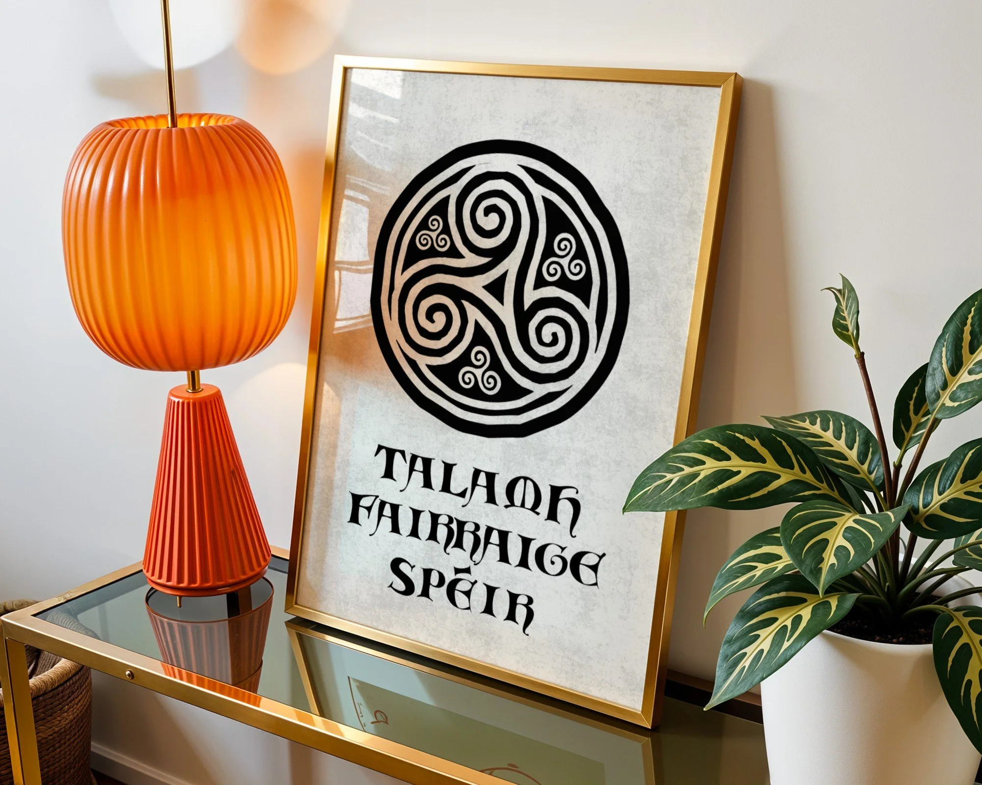Decorative side table with an orange lamp, a framed poster with tribal patterns and words, and green leafy plants in a bright room. Triskelion Irish art