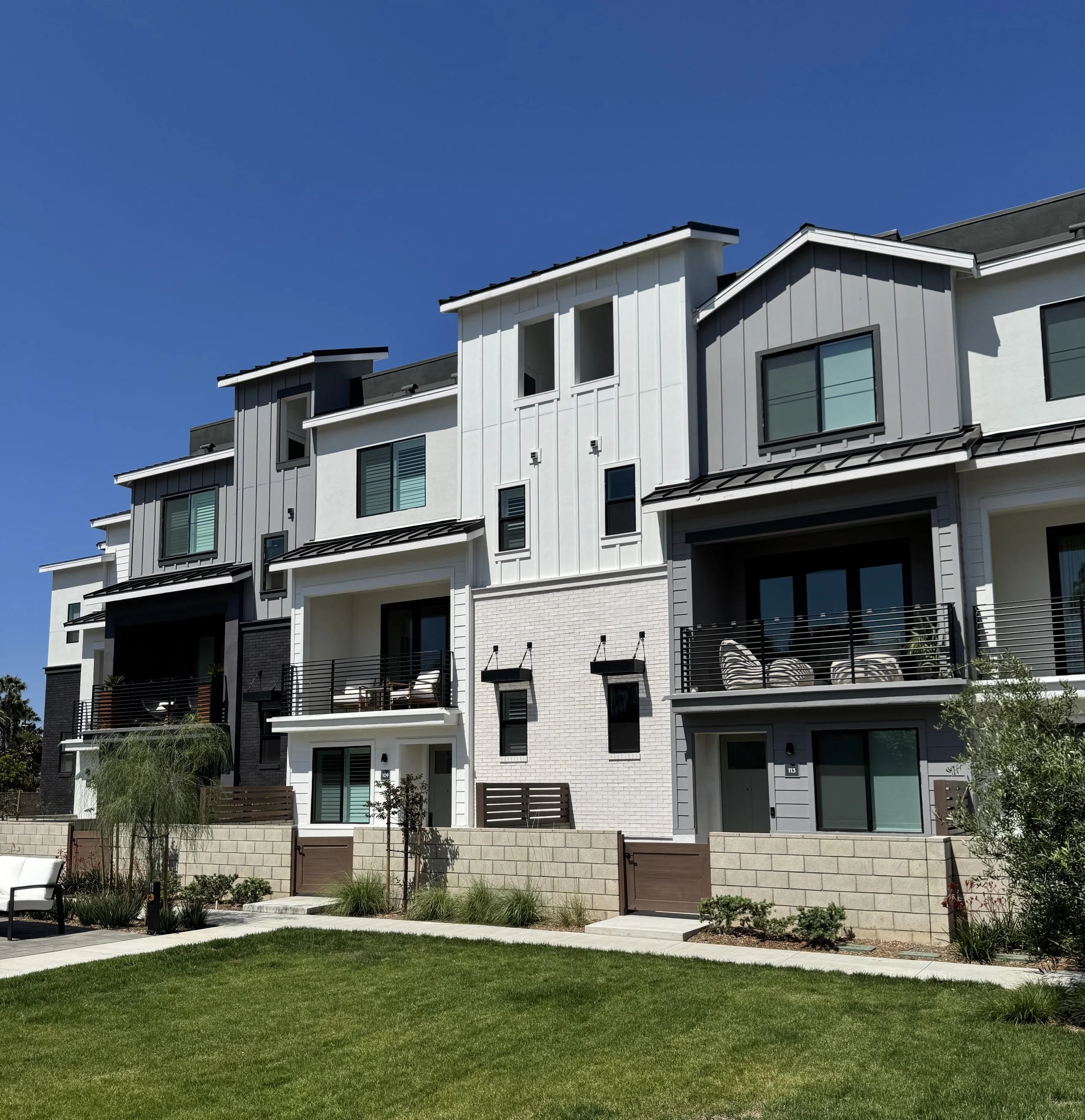 Coastlands townhomes for sale in Huntington Beach, CA featuring a front shot of several of the units.