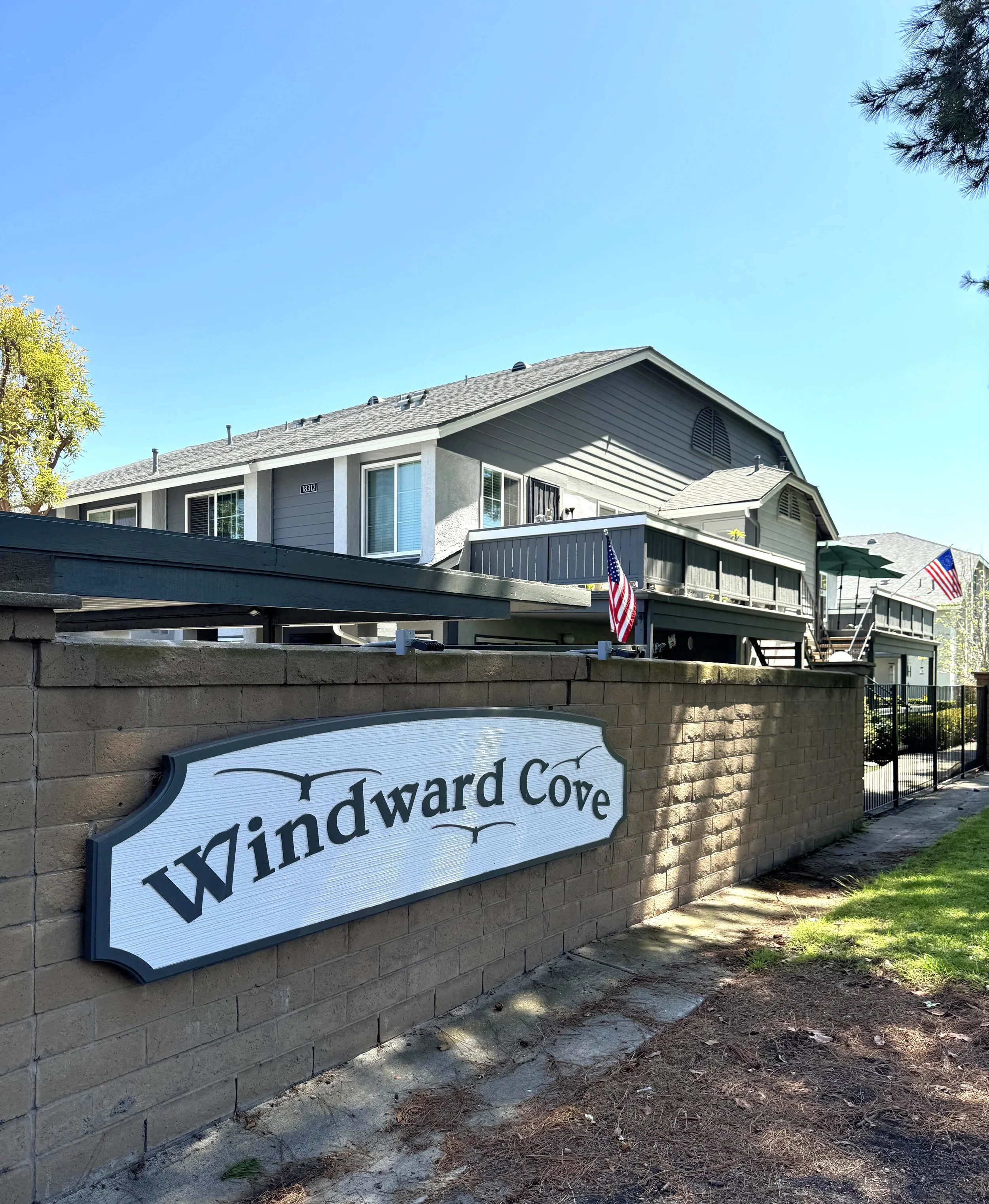 Windward Cove condos for sale in Huntington Beach, CA featuring the community entrance sign placard.