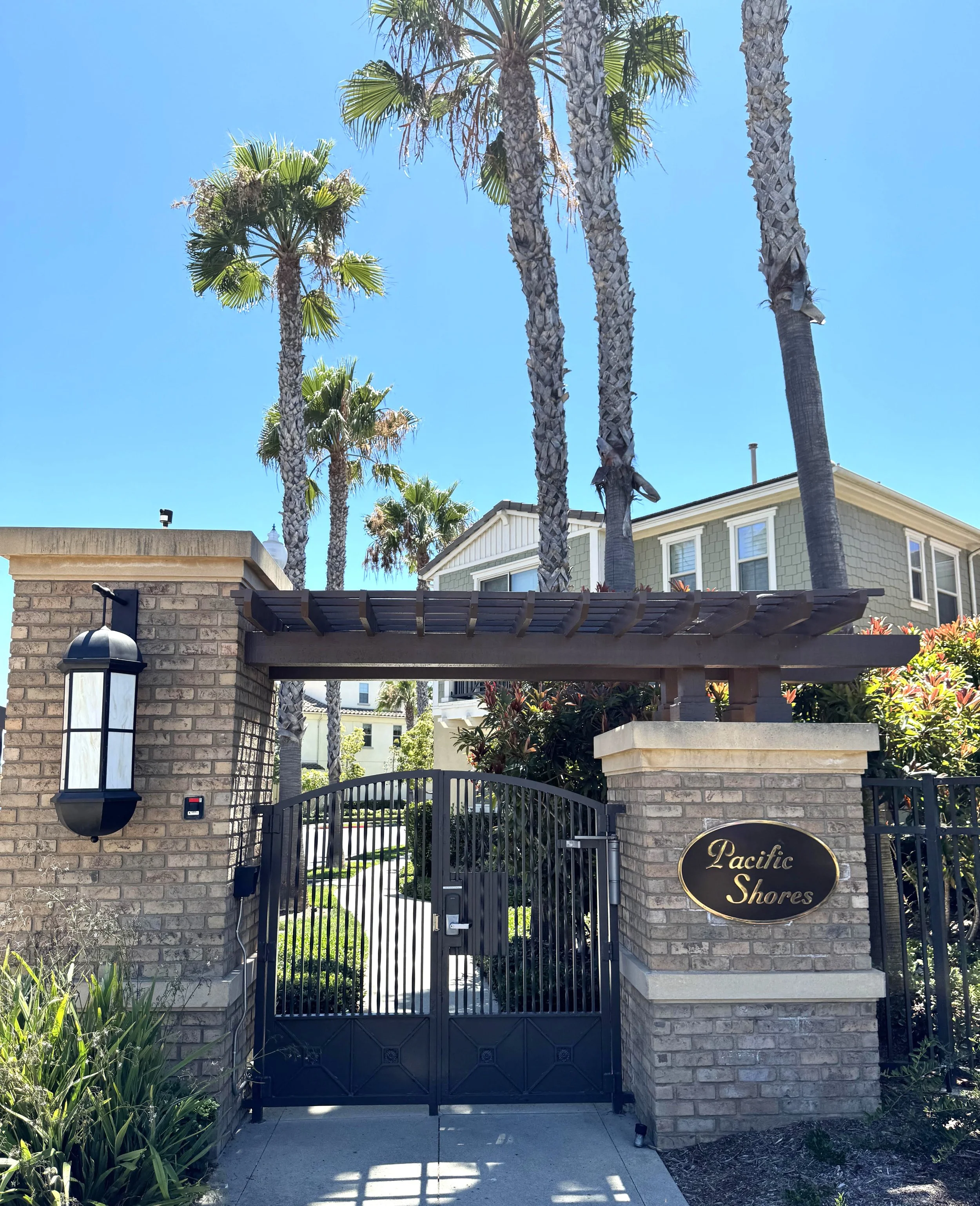 Pacific Shores Villas & Bungalows for sale in Huntington Beach featuring the community sign entrance placard.